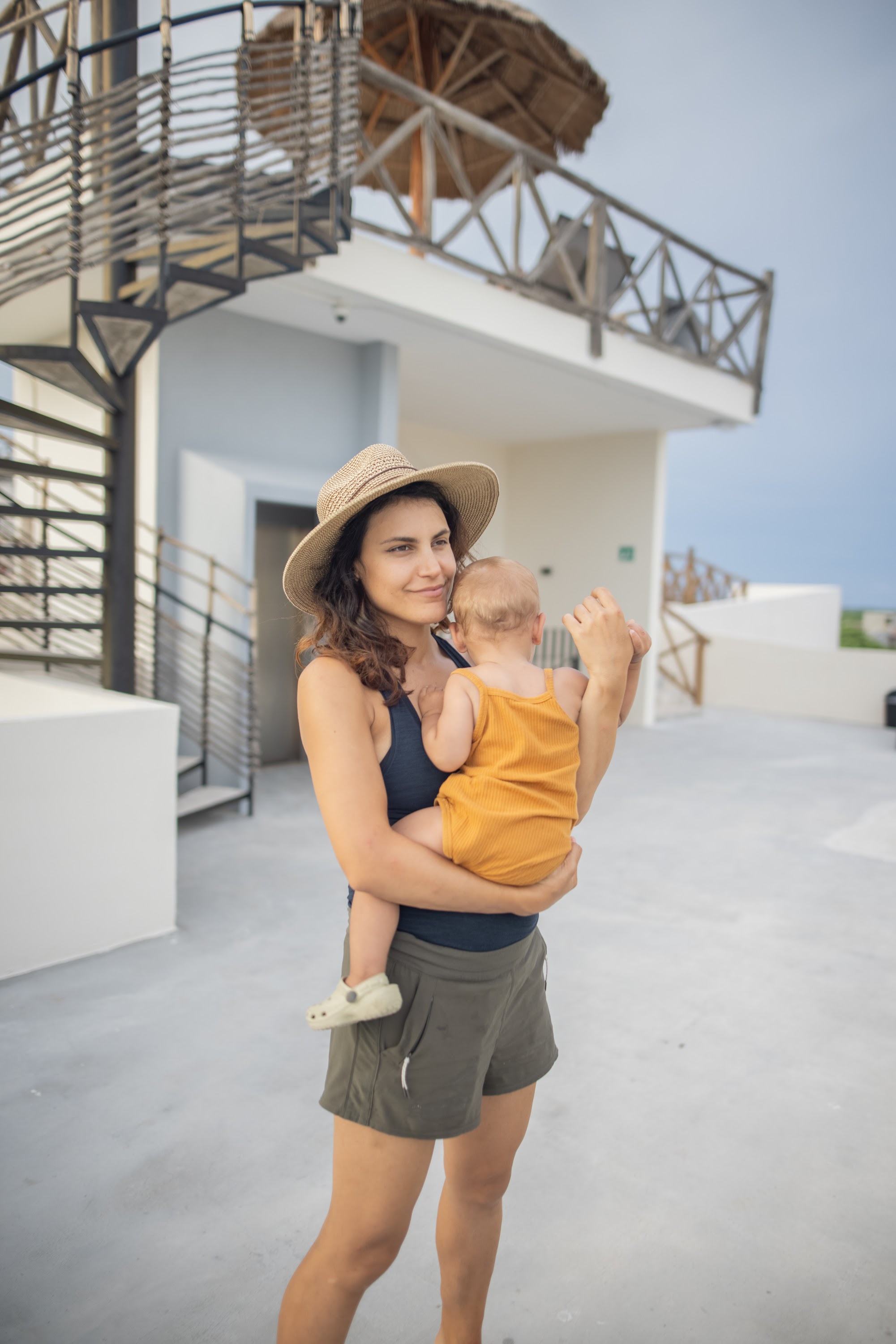 Mother Holding Baby on Rooftop Terrace