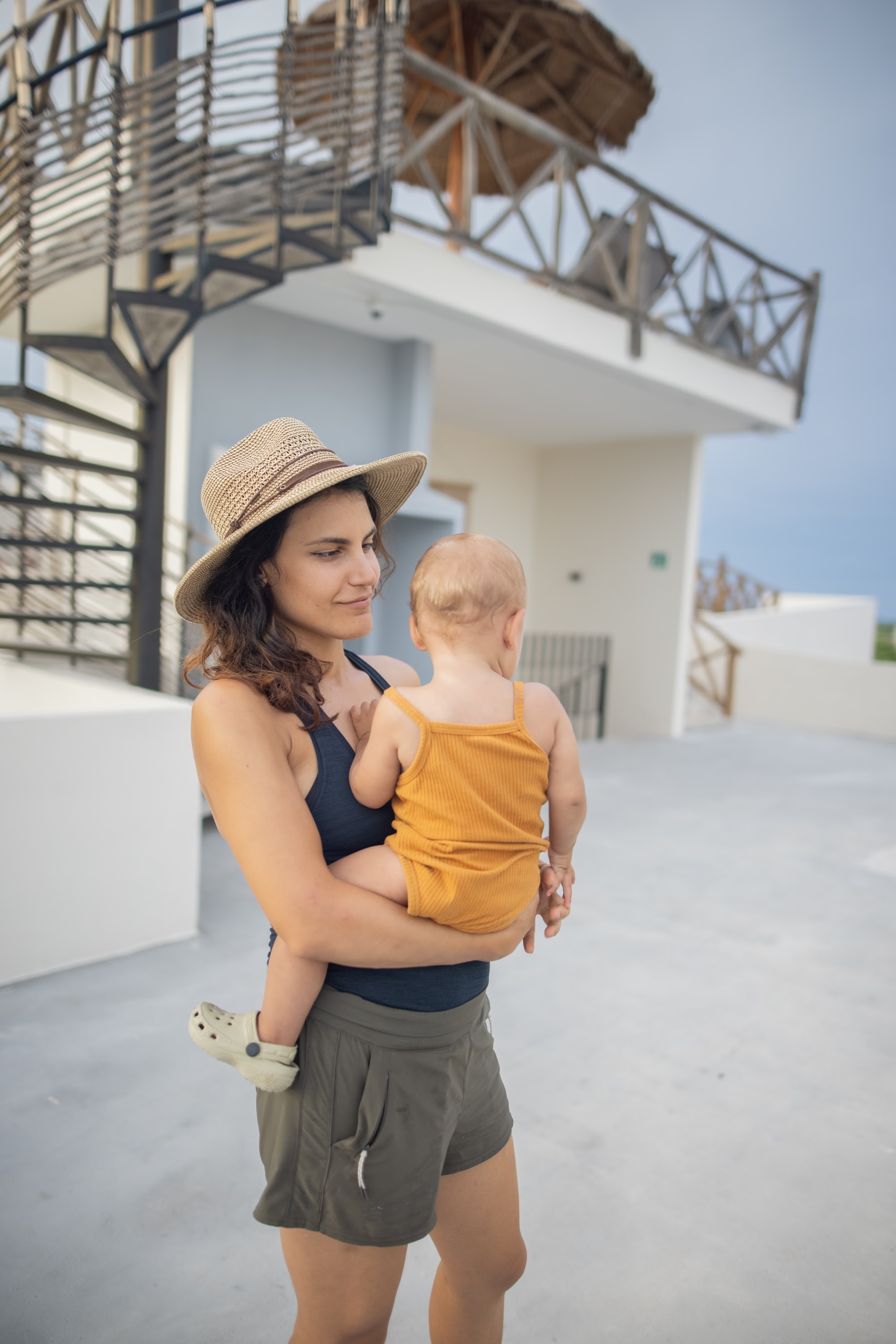 Mother Holding Baby on Rooftop Terrace