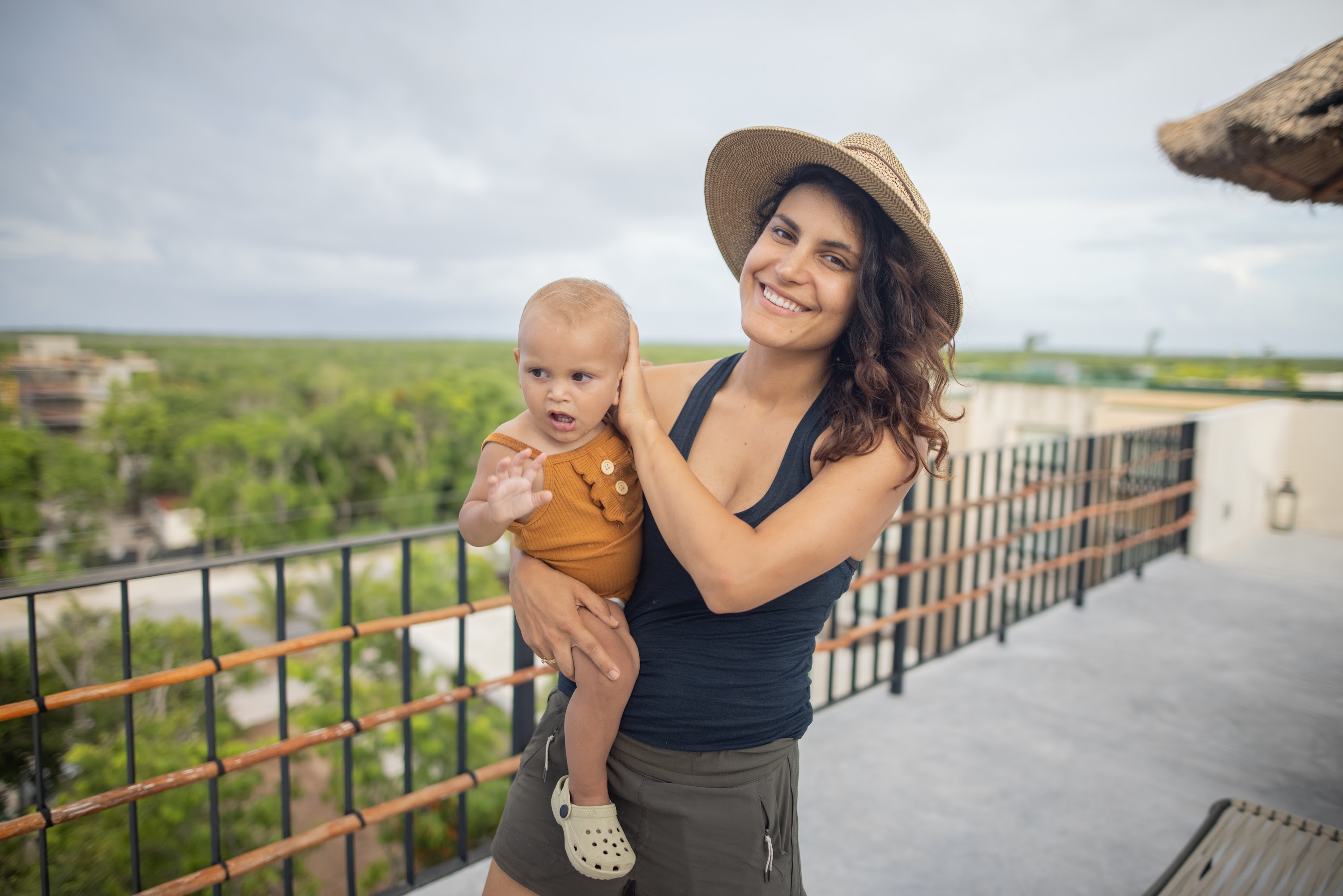 Mother Holding Baby on Balcony