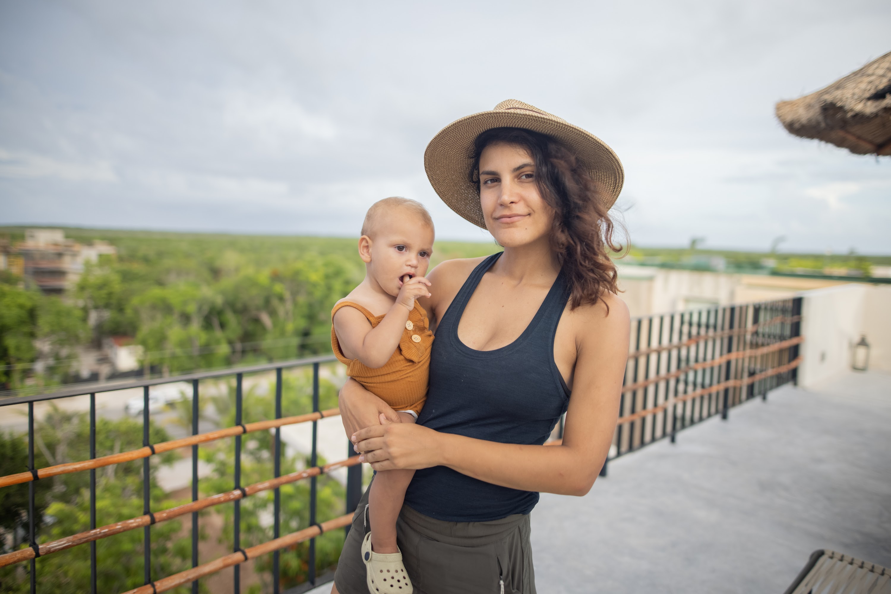 Mother Holding Baby on Balcony