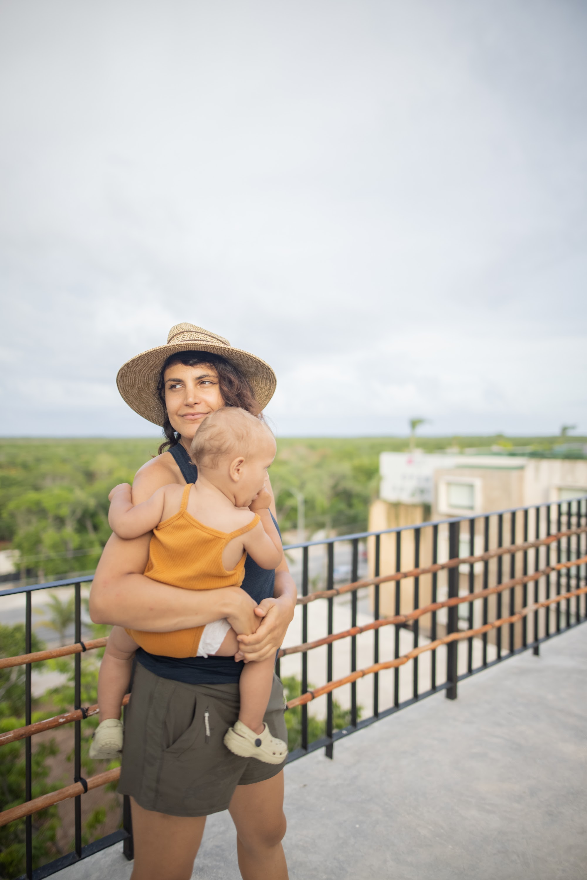 Mother Holding Baby on Balcony