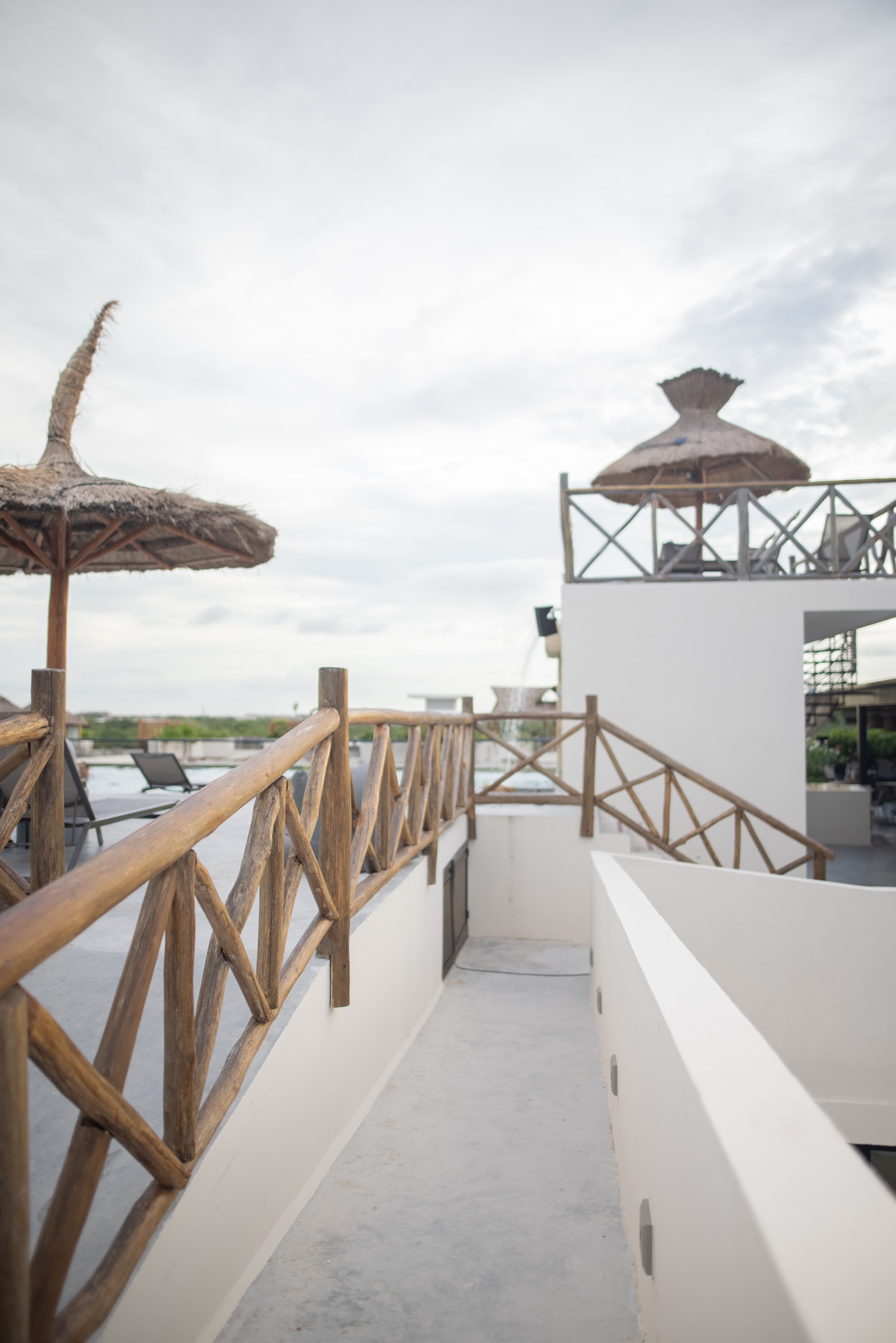 Rooftop Terrace with Thatched Umbrellas and Bamboo Railings