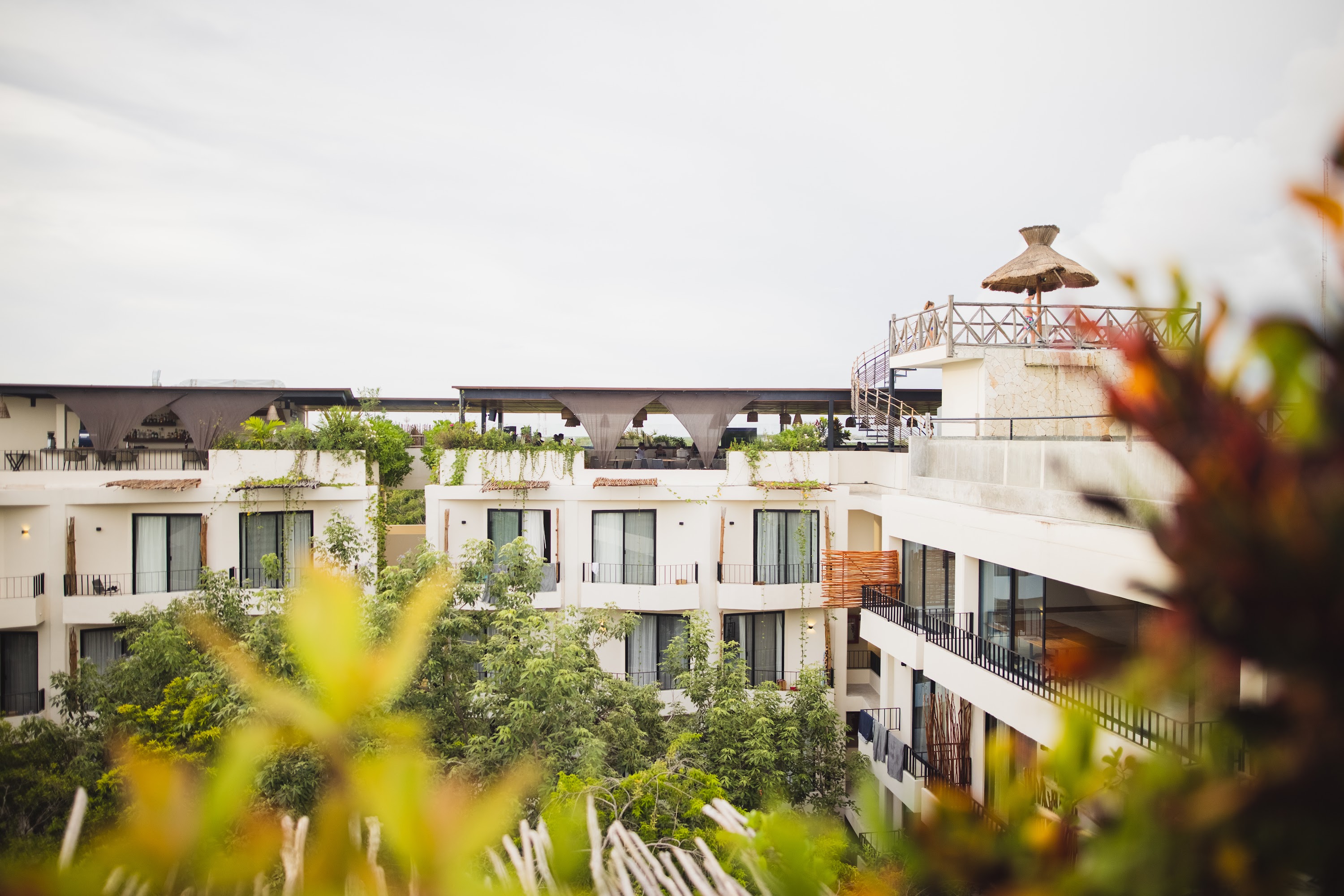 Modern Resort Buildings with Rooftop Terrace and Thatched Umbrella