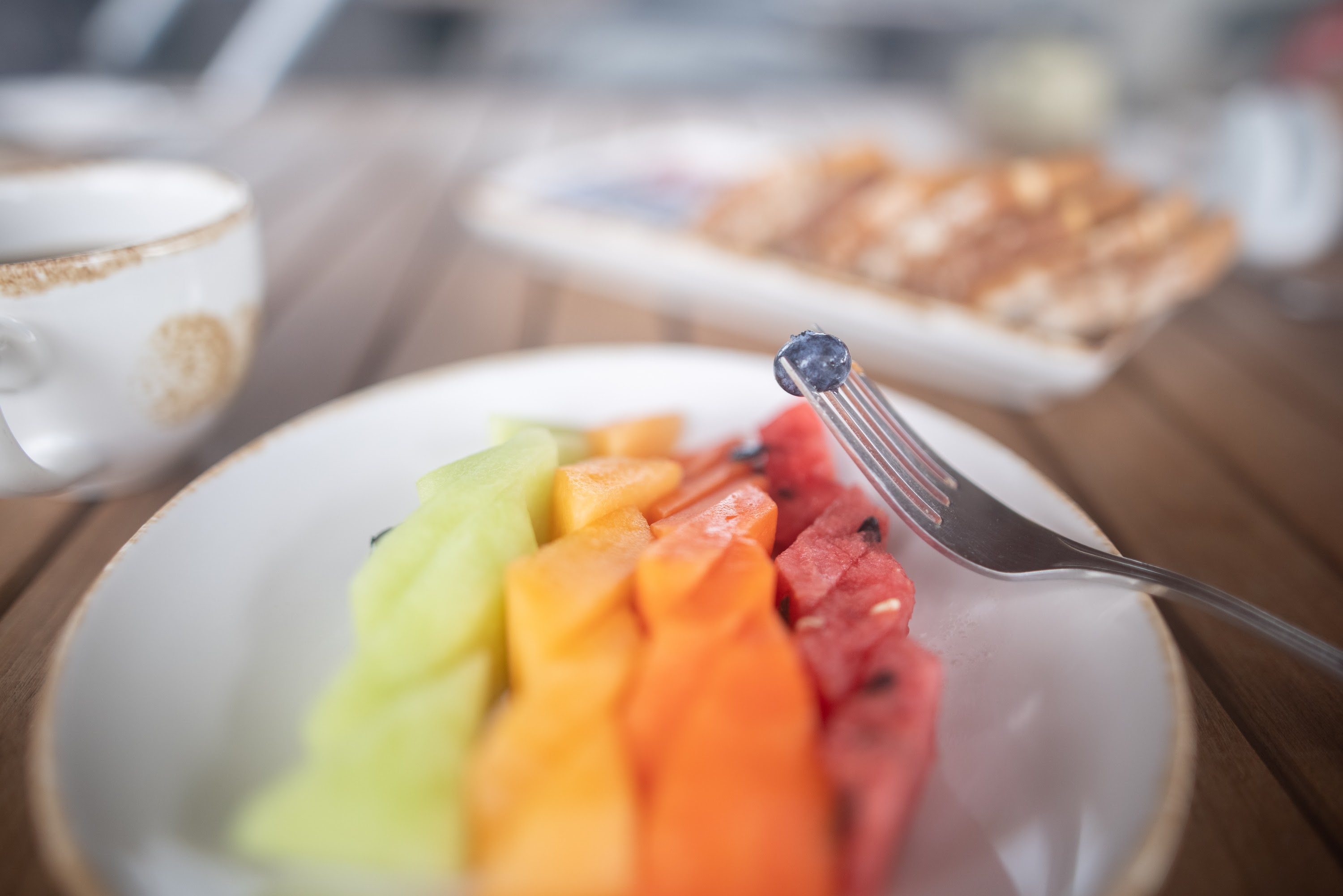 Rainbow Fruit Platter with Blueberry on Fork