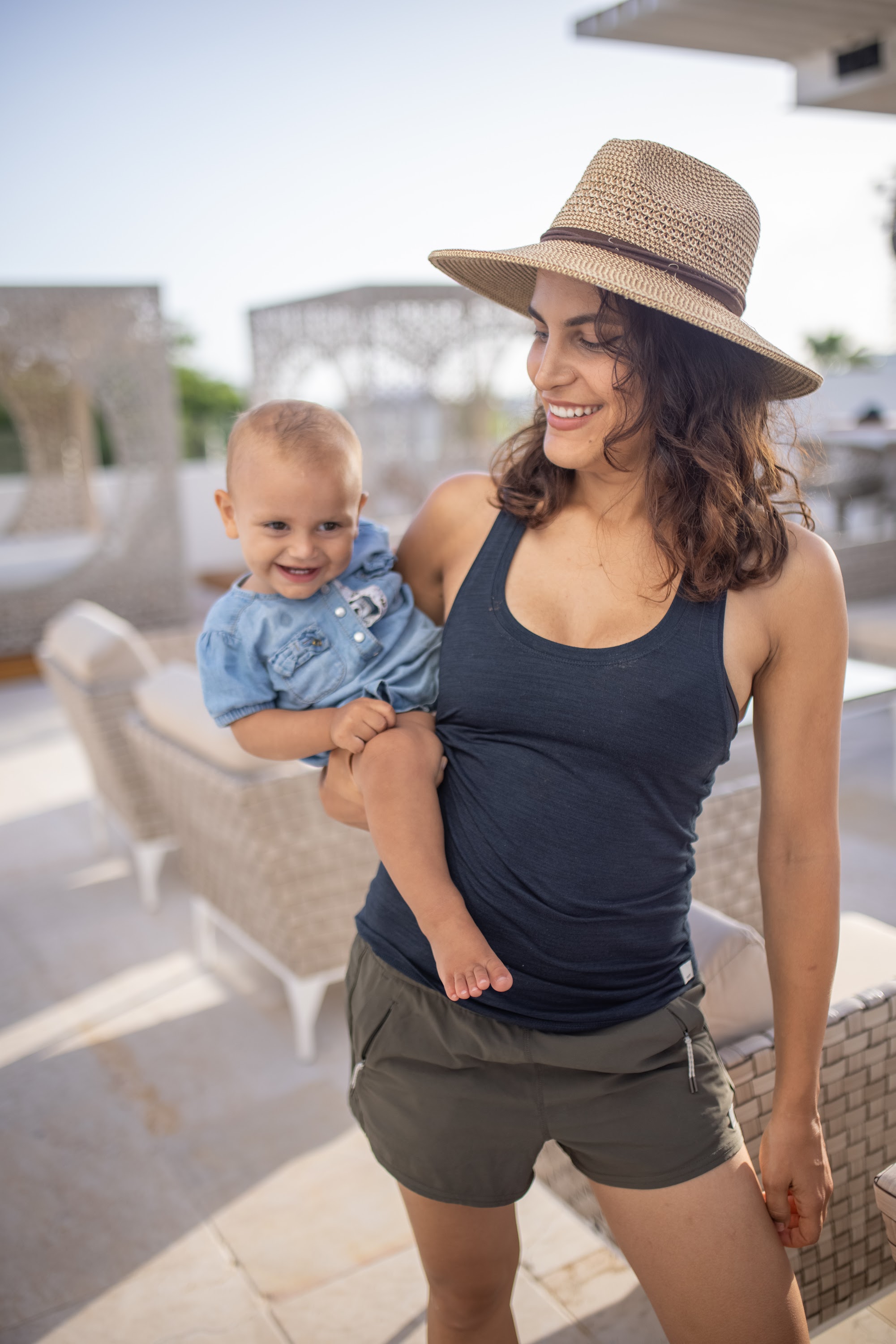 Mother Holding Baby Son on Sunlit Patio