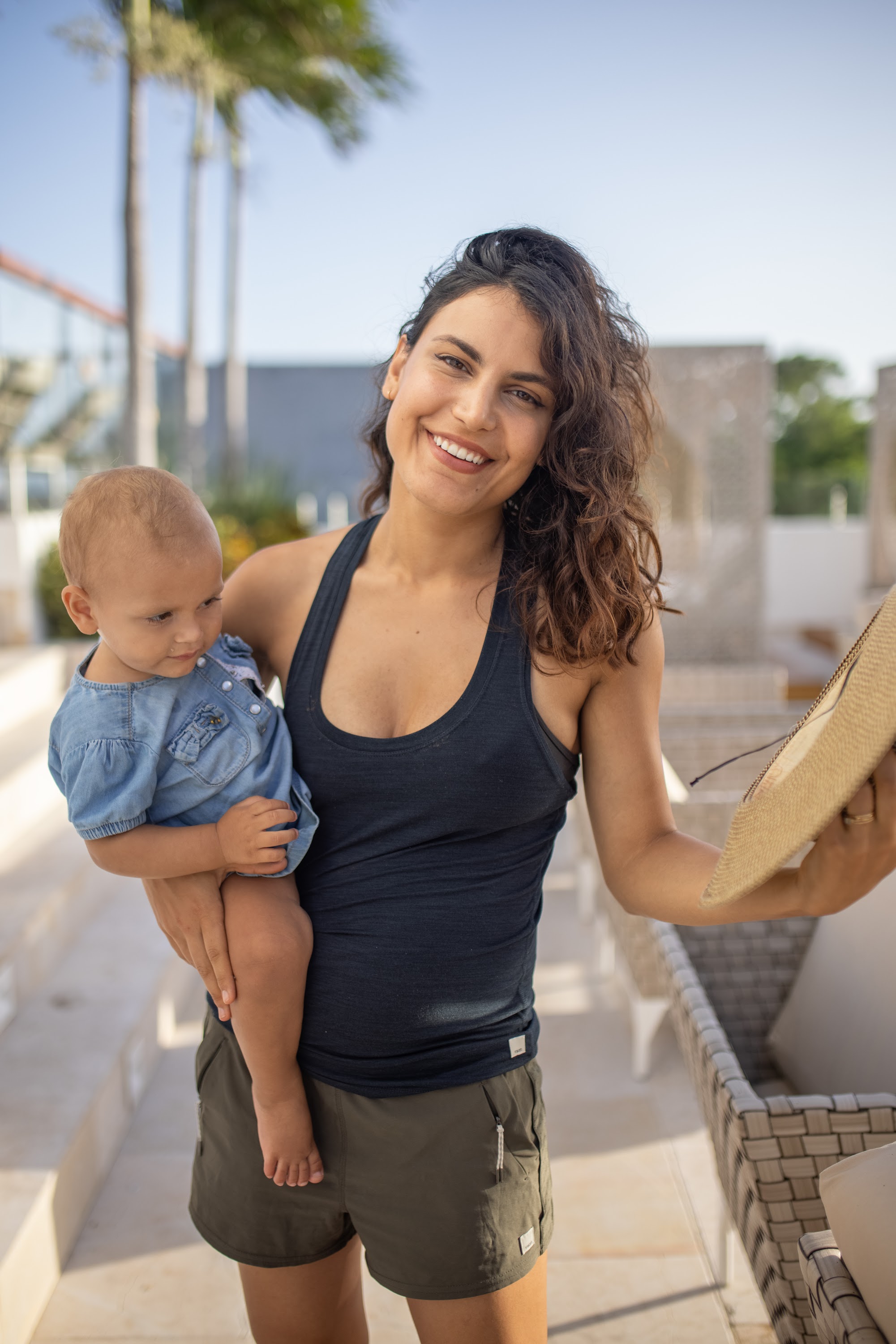 Smiling Woman Holding Baby Outdoors