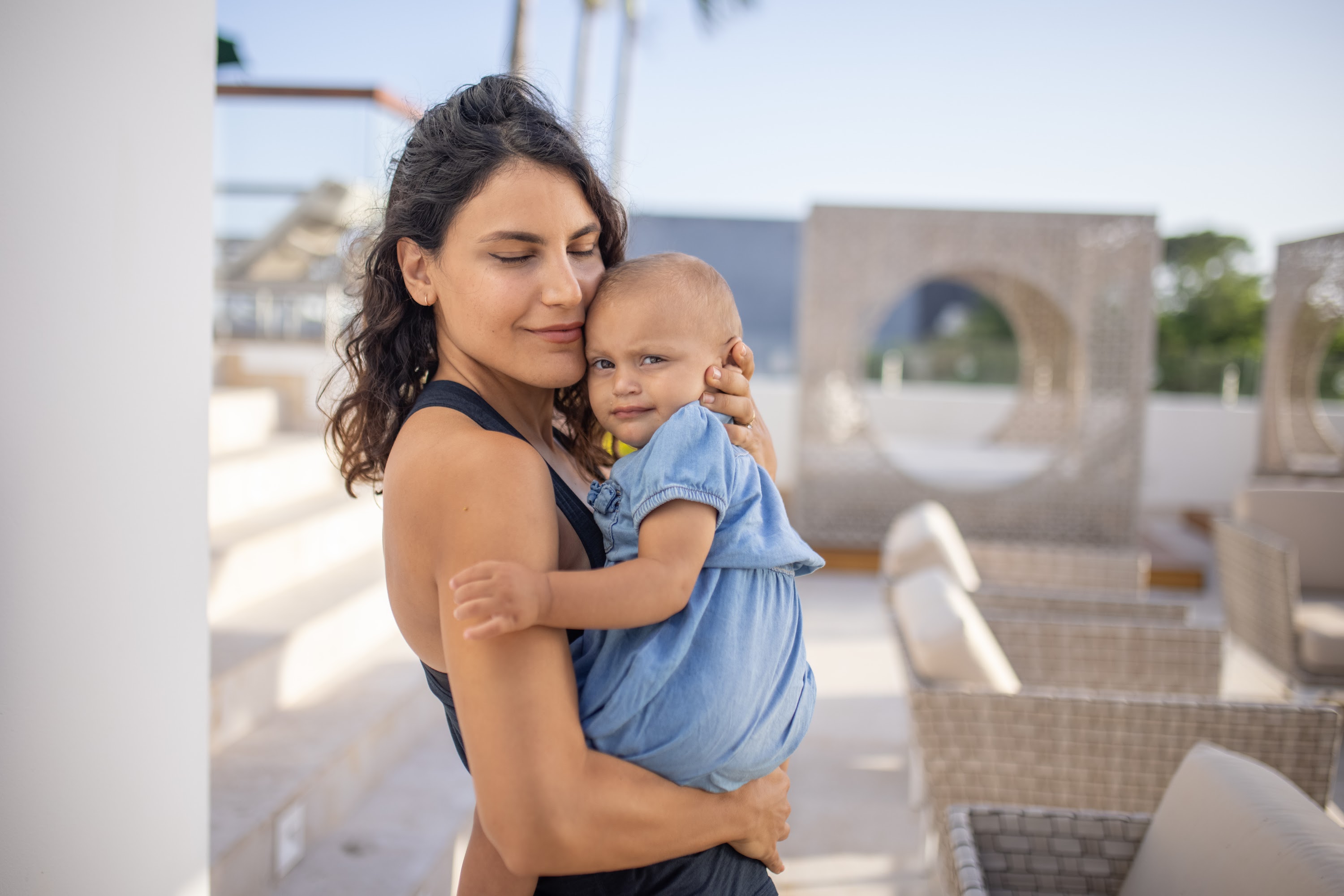 Mother Holding Baby on Rooftop Terrace