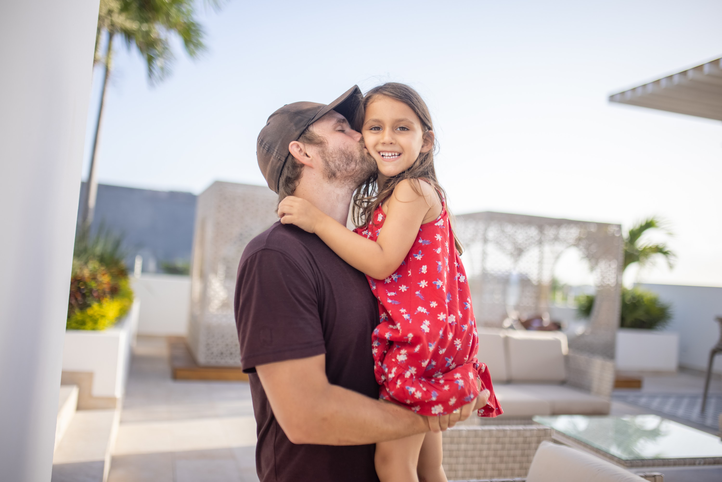 Father Kissing Daughter on the Cheek Outdoors