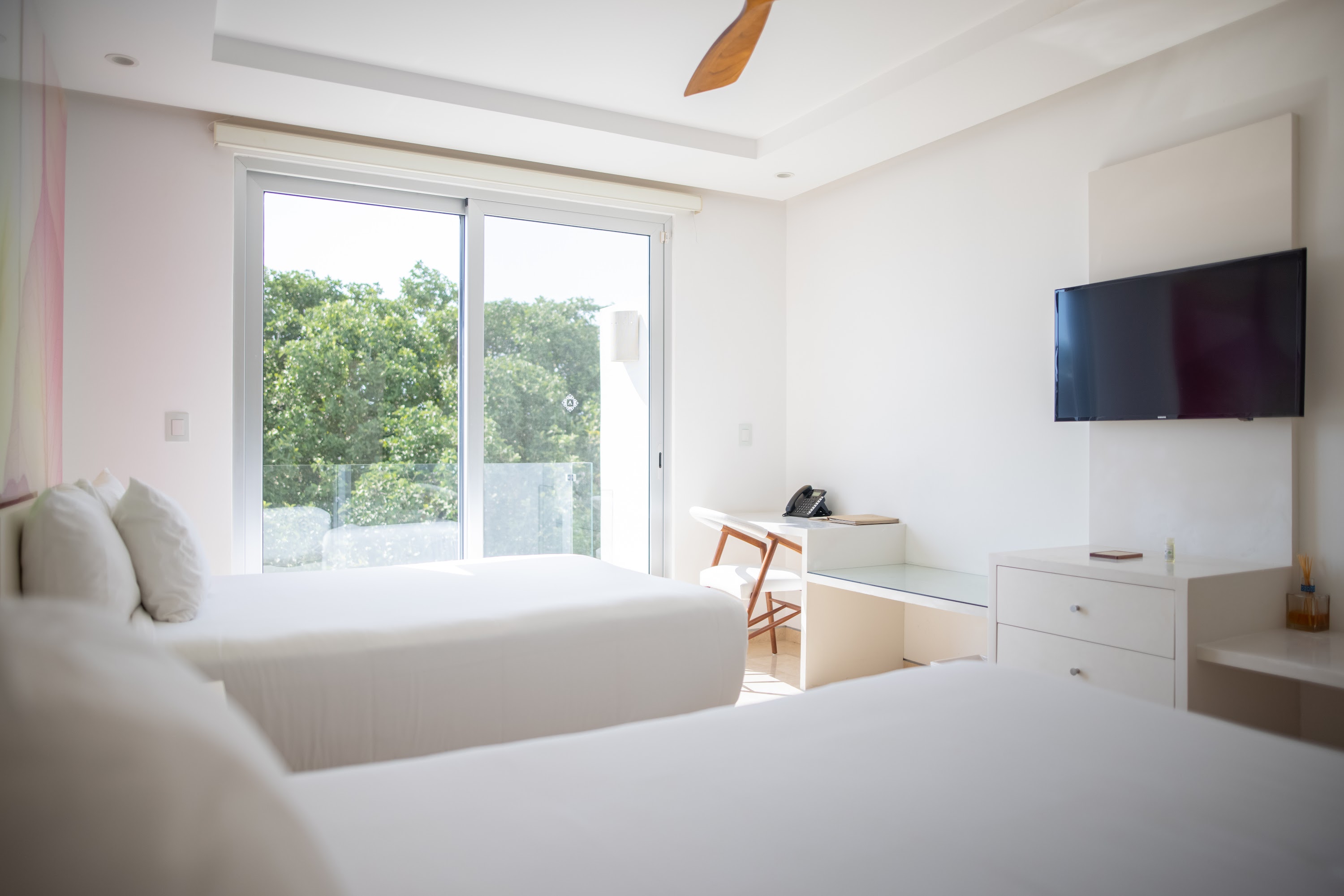 Modern White Hotel Room with Two Beds and Balcony View