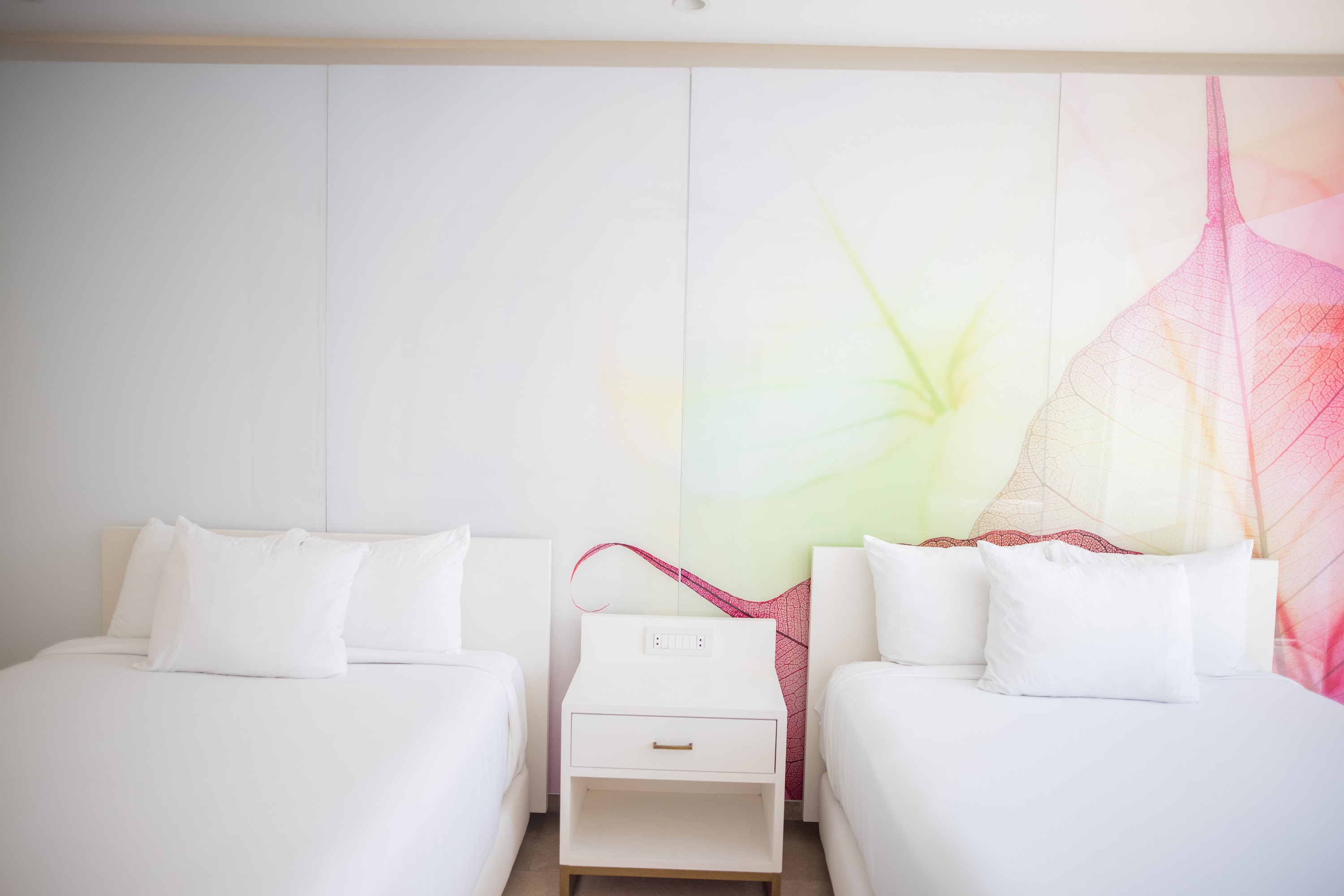 Modern Hotel Room with Two Twin Beds and Leaf Wall Art