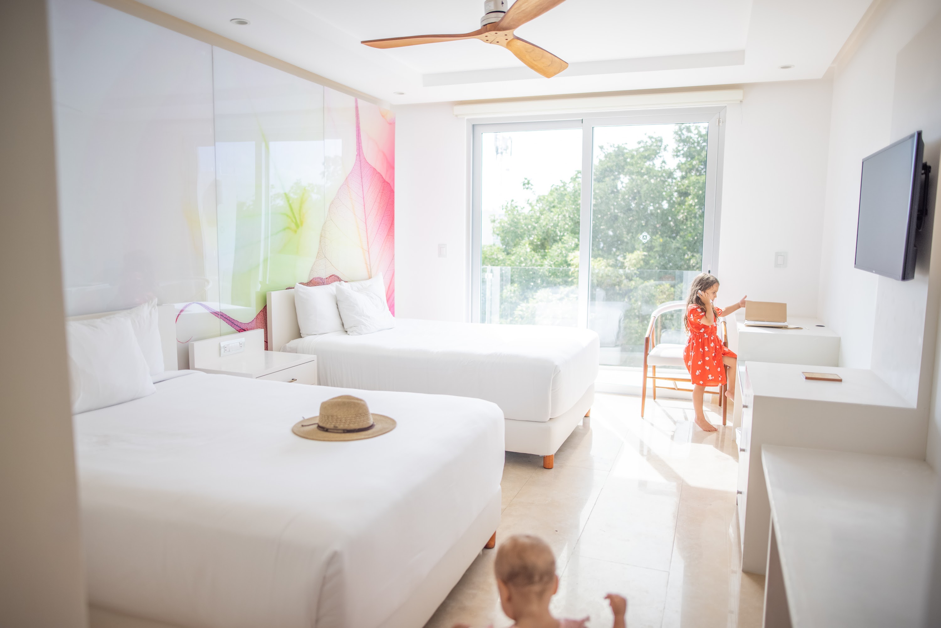 Children in a Bright Hotel Room with Two Beds
