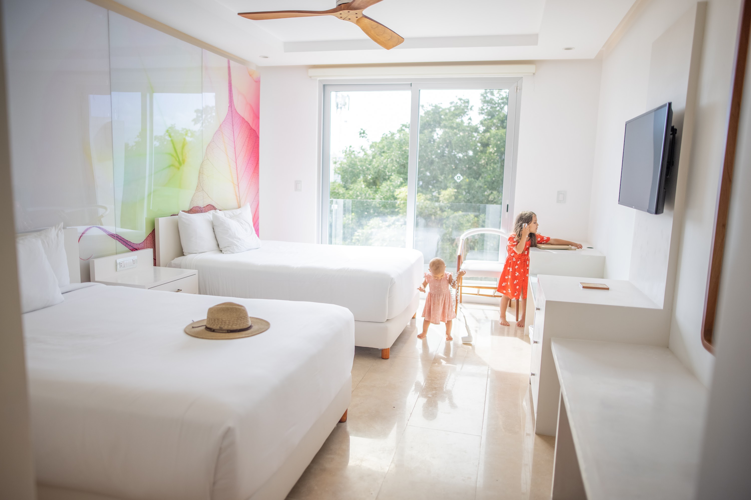 Children in a Bright Hotel Room with Two Beds