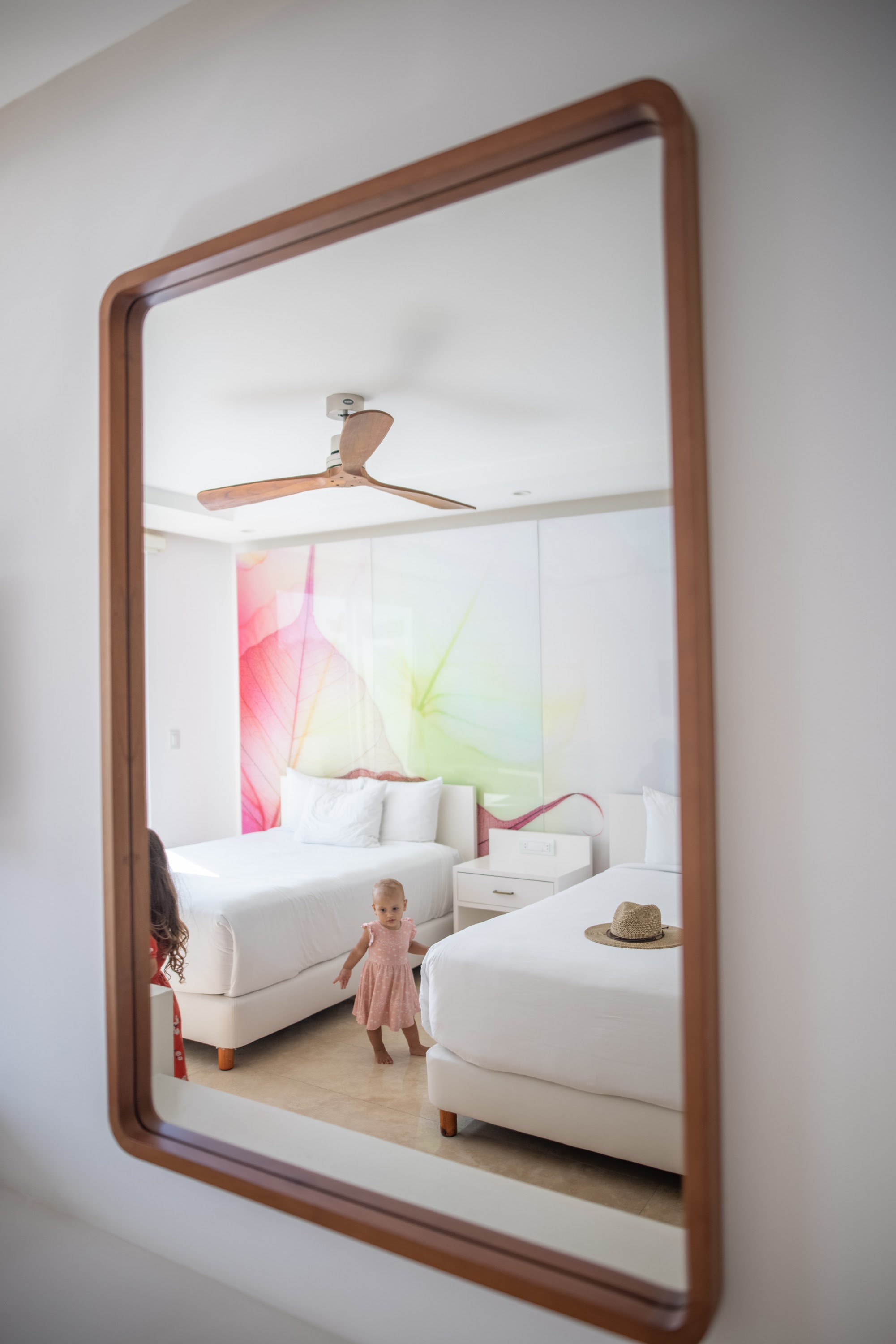 Child in Pink Dress Reflected in Wooden Mirror