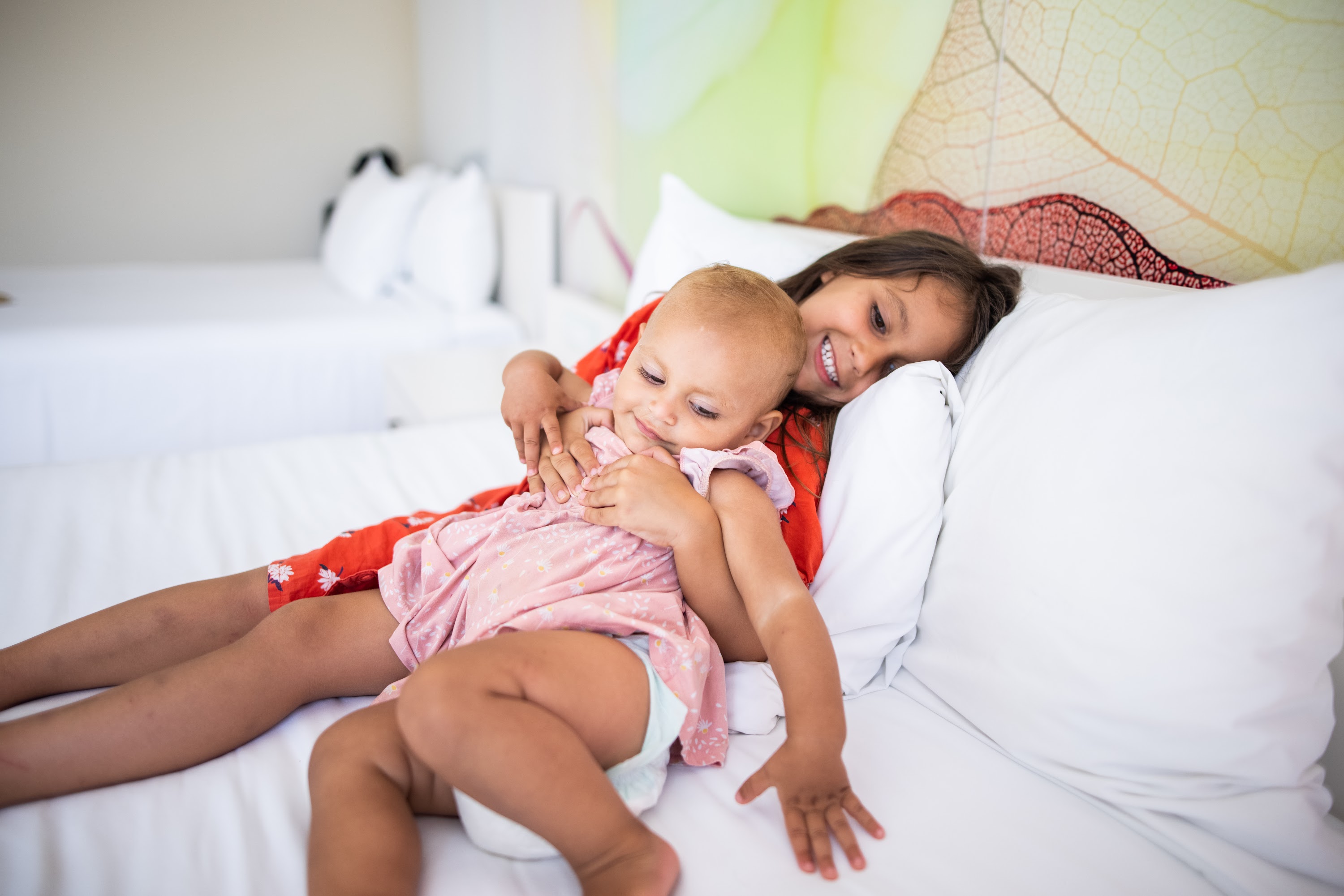 Sisters Embracing on a Bed