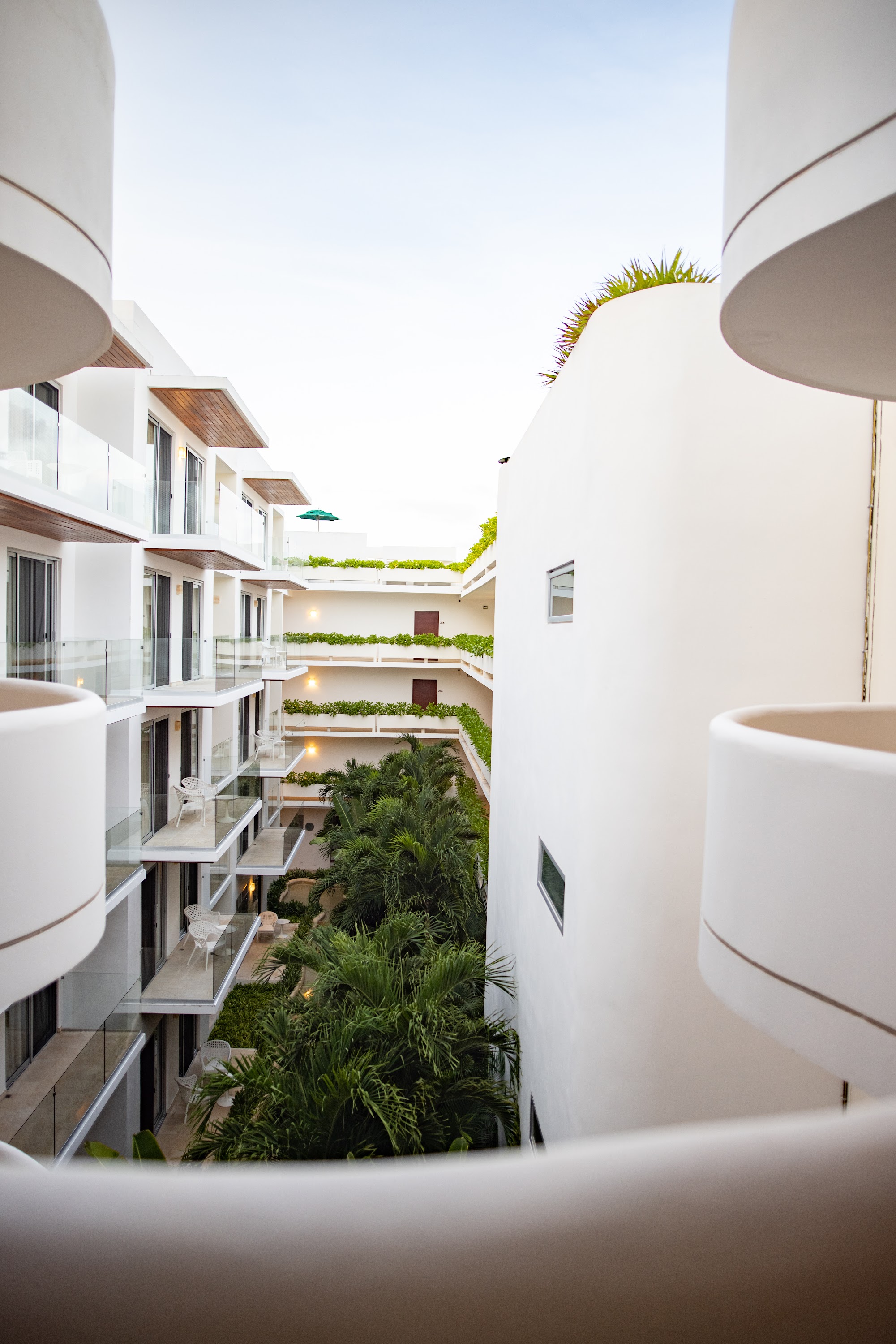 Modern White Apartment Complex with Tropical Greenery