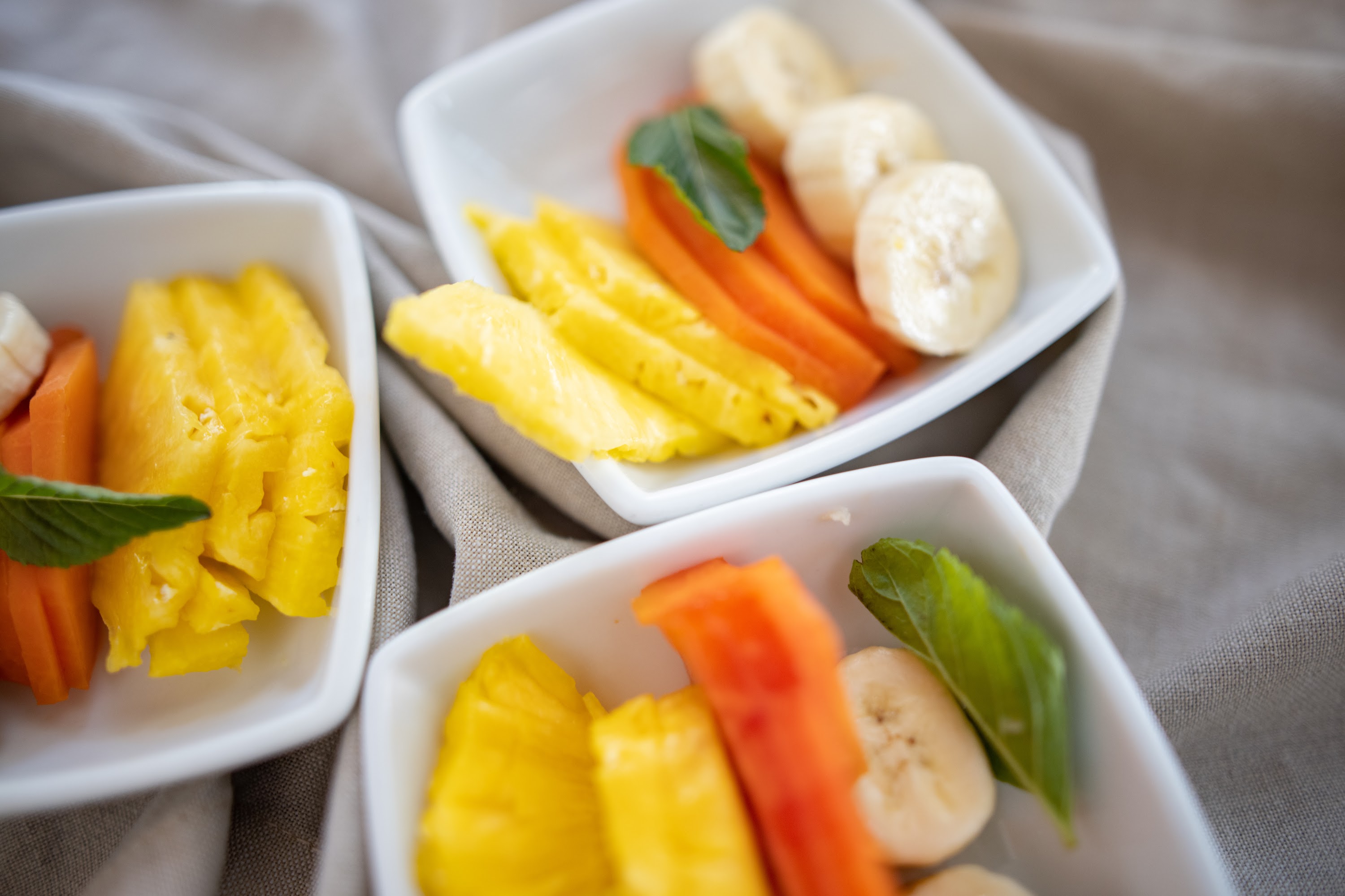 Assorted Fruit Slices in White Bowls