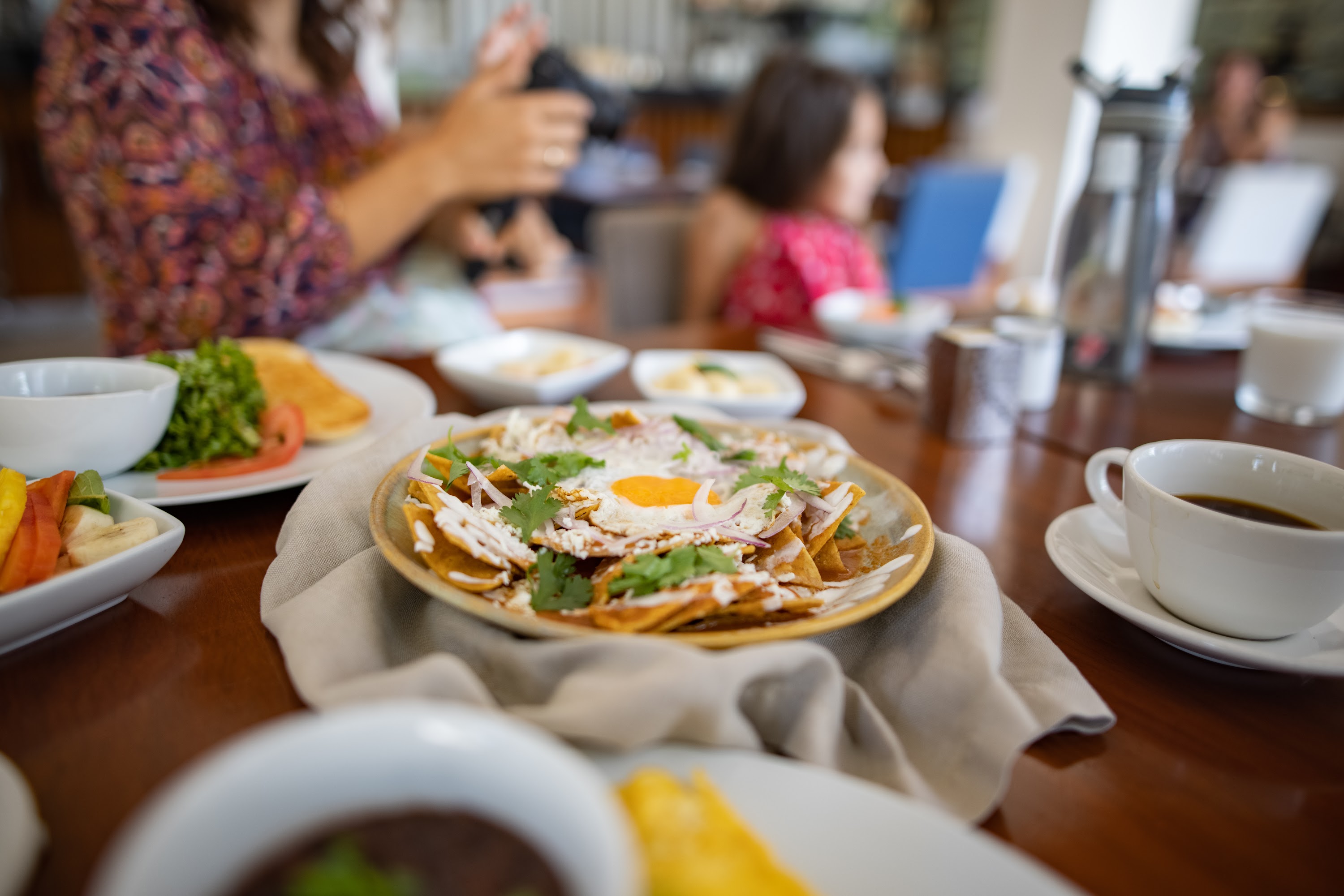 Family Dining at a Café with Chilaquiles