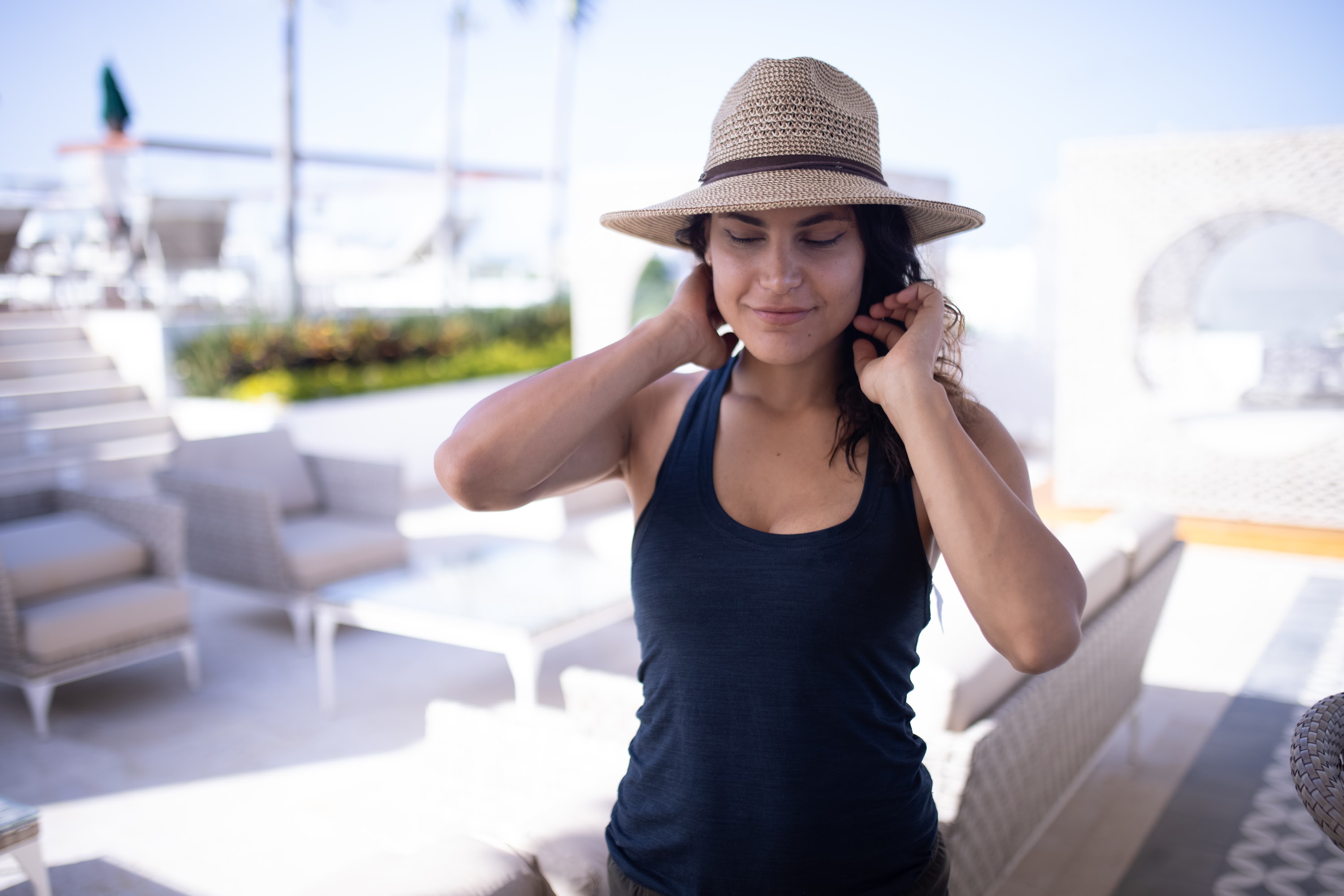 Woman Adjusting Earrings Outdoors