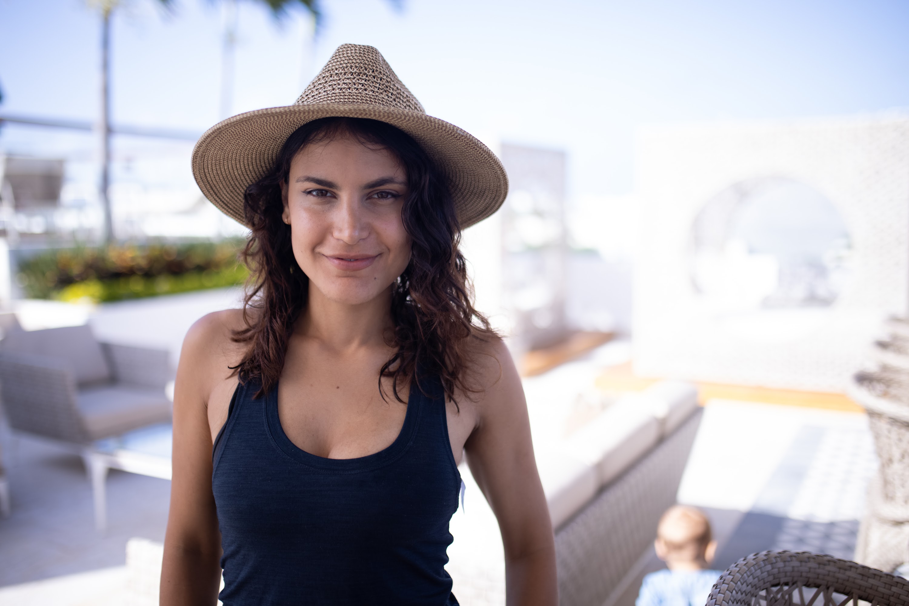 Woman in Straw Hat Smiling Outdoors