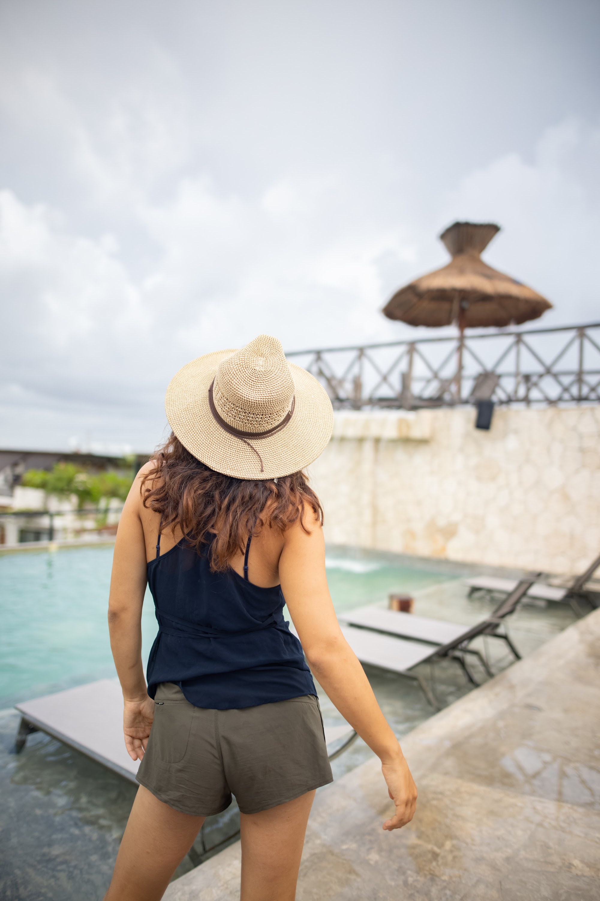 Woman in Straw Hat by Poolside