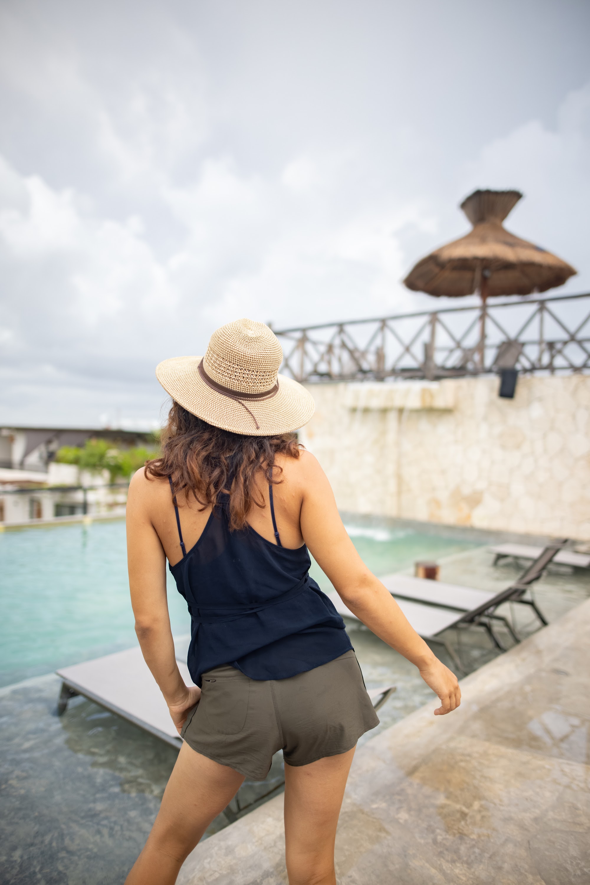 Woman in Straw Hat by Poolside