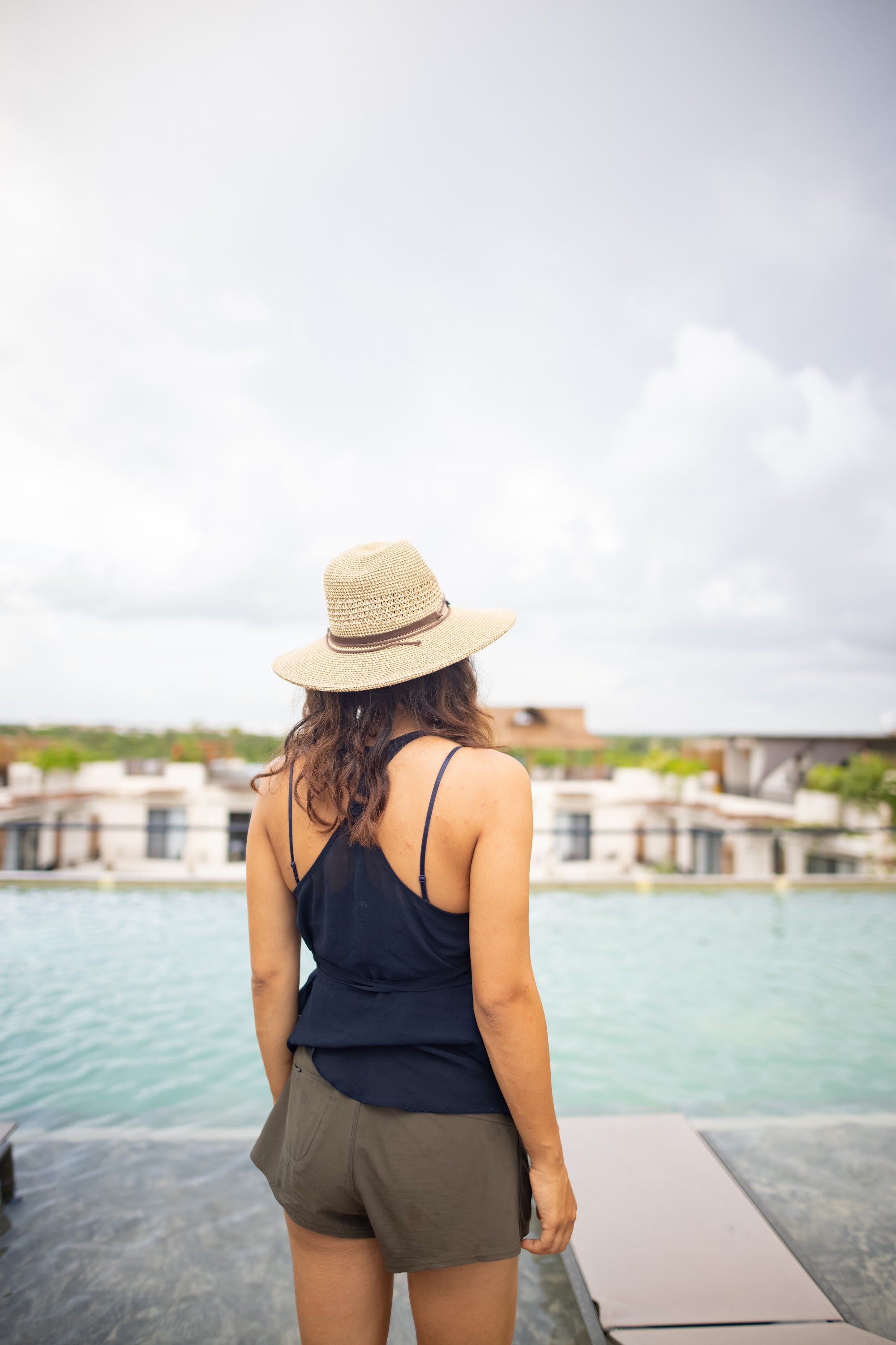 Woman in Straw Hat Standing by Pool