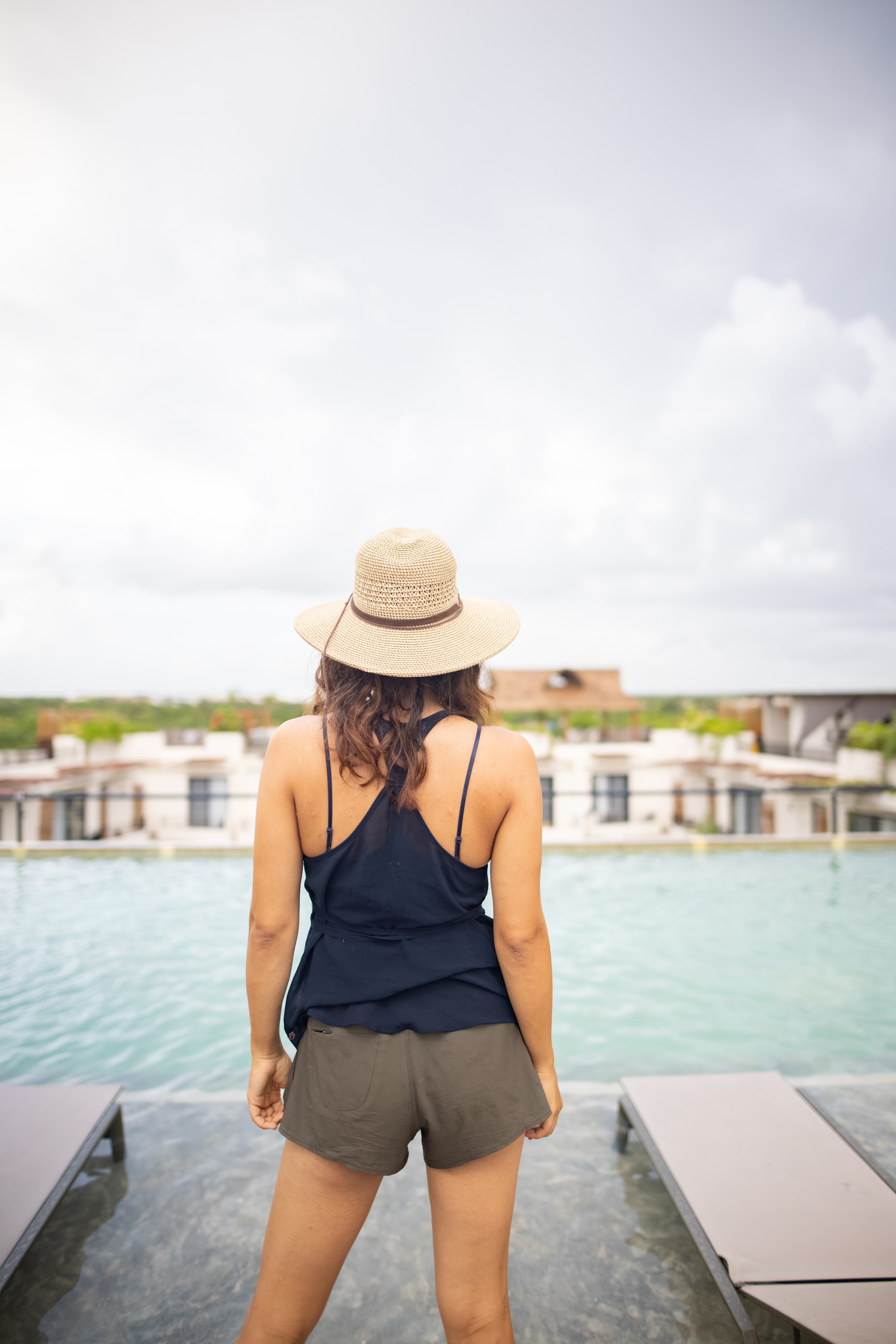 Woman in Straw Hat Standing by Pool