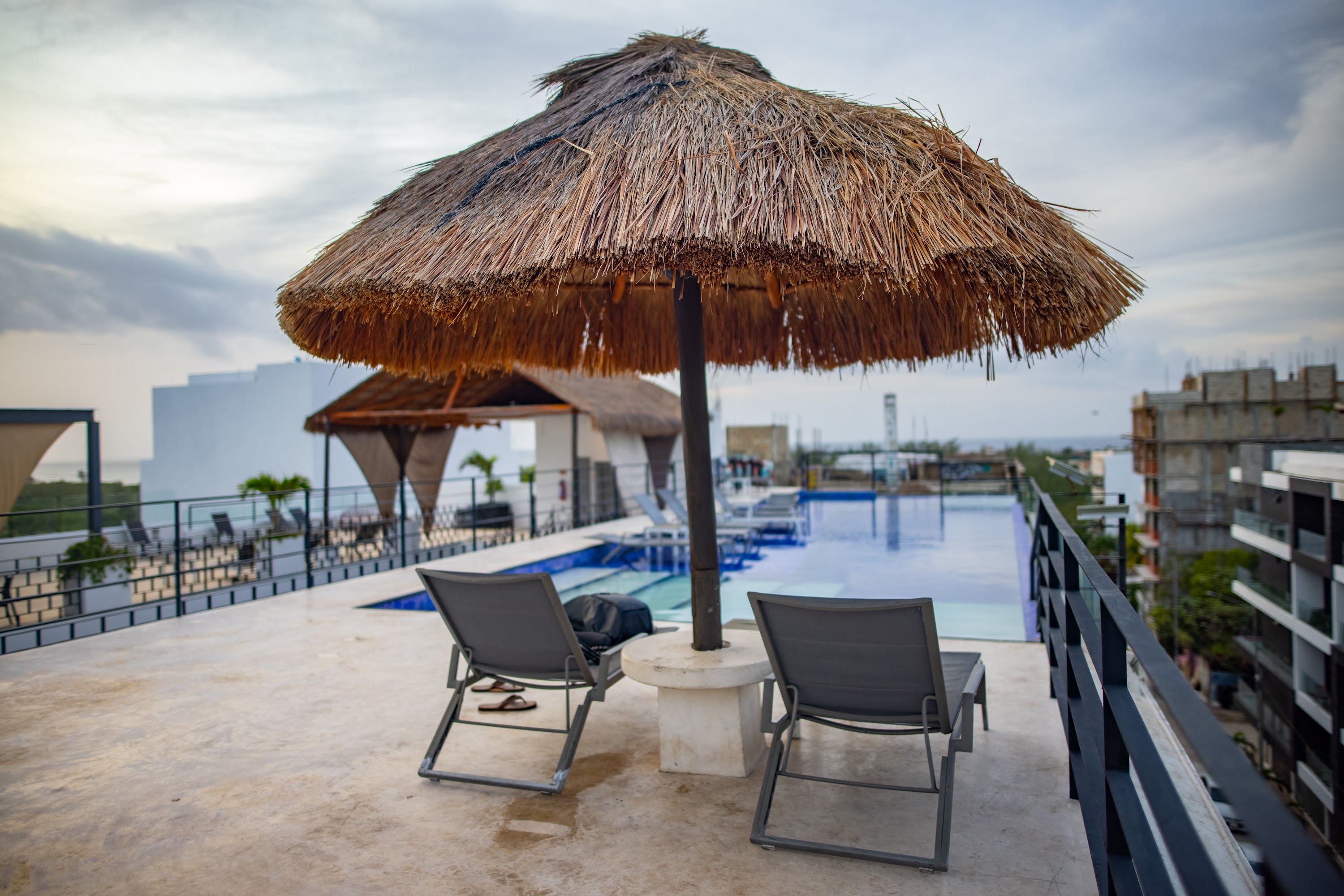 Rooftop Poolside Relaxation with Thatch Umbrella