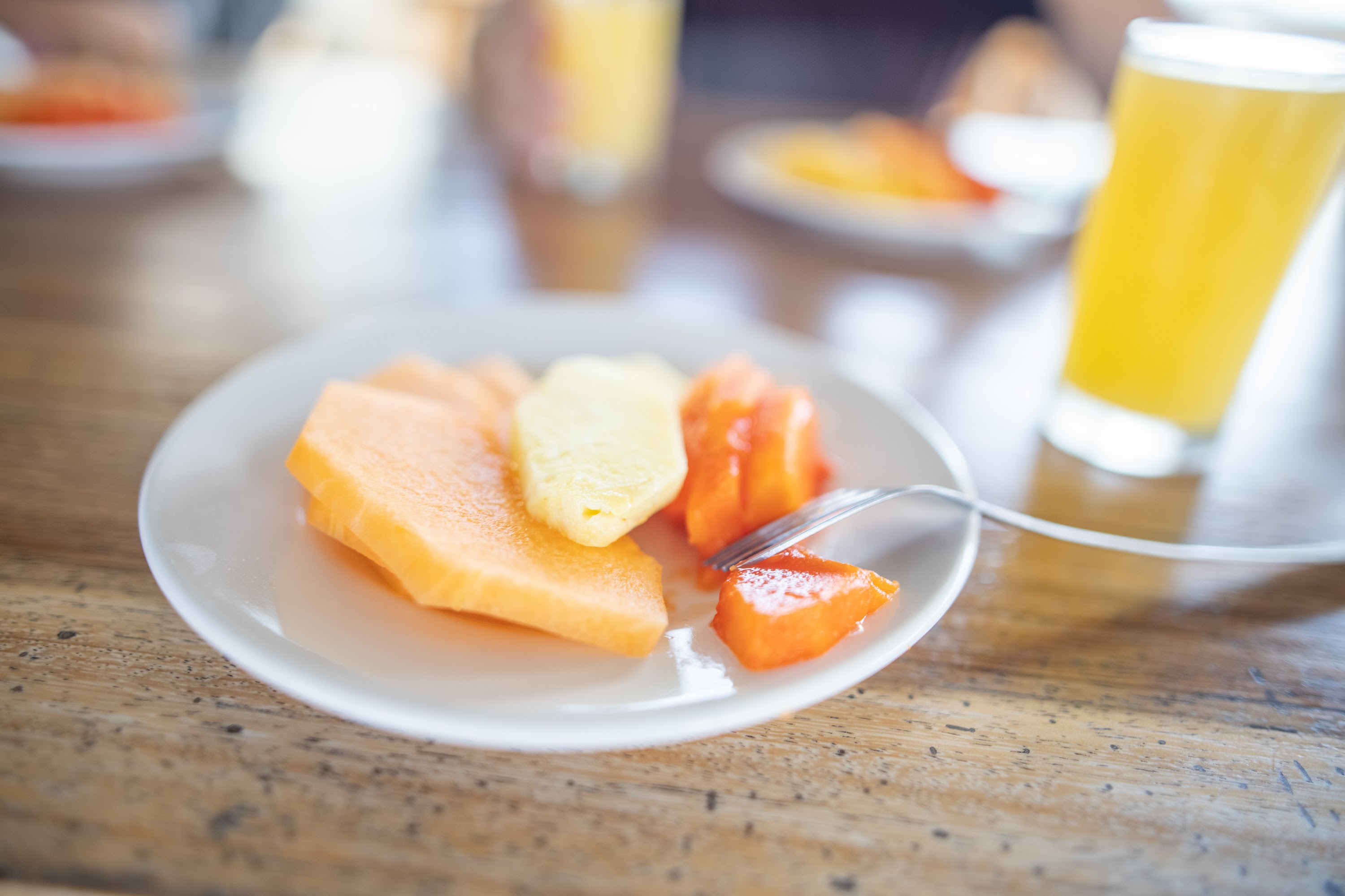 Plate of Fresh Fruit Slices with Orange Juice