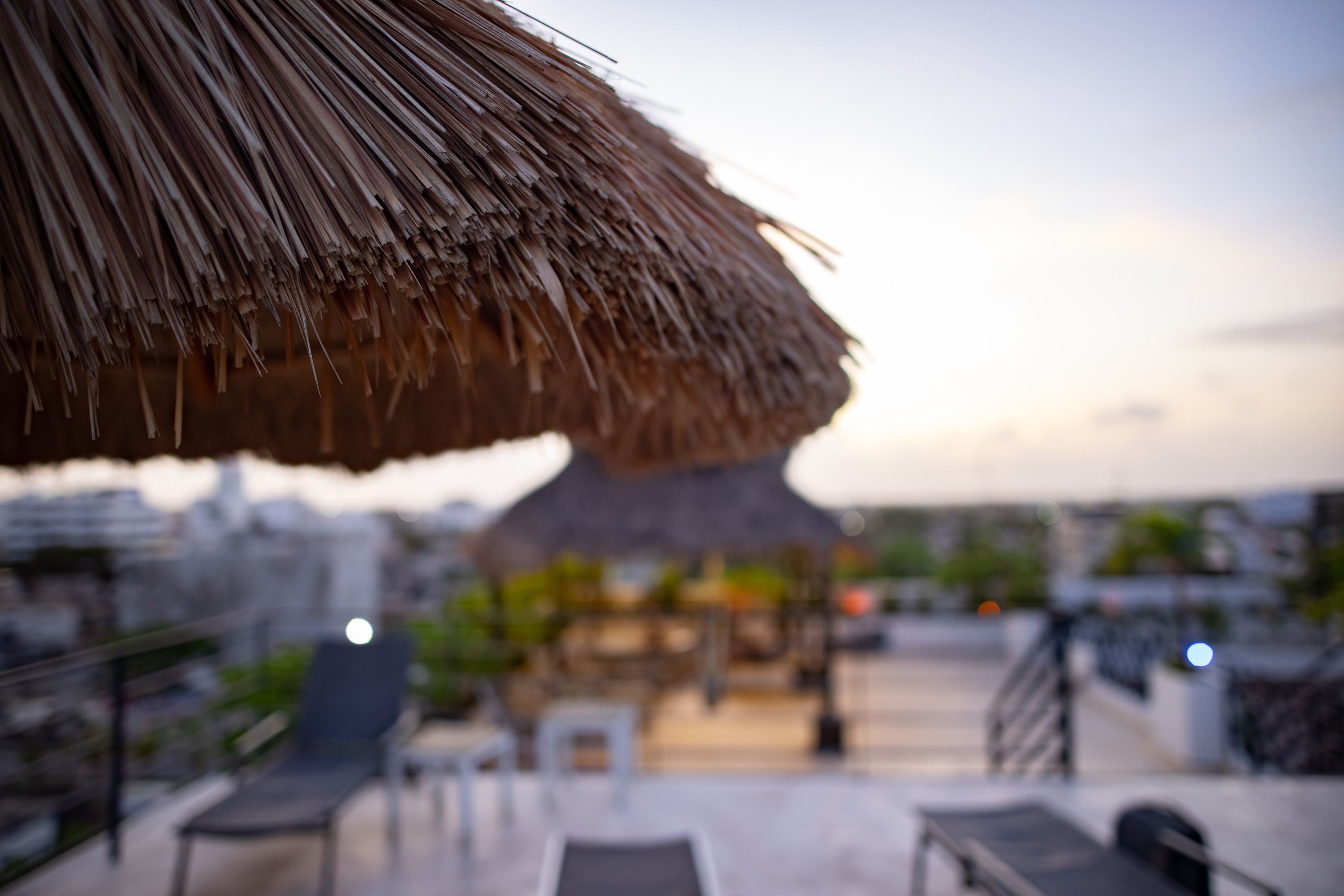 Rooftop Terrace at Dusk with Thatch Umbrella