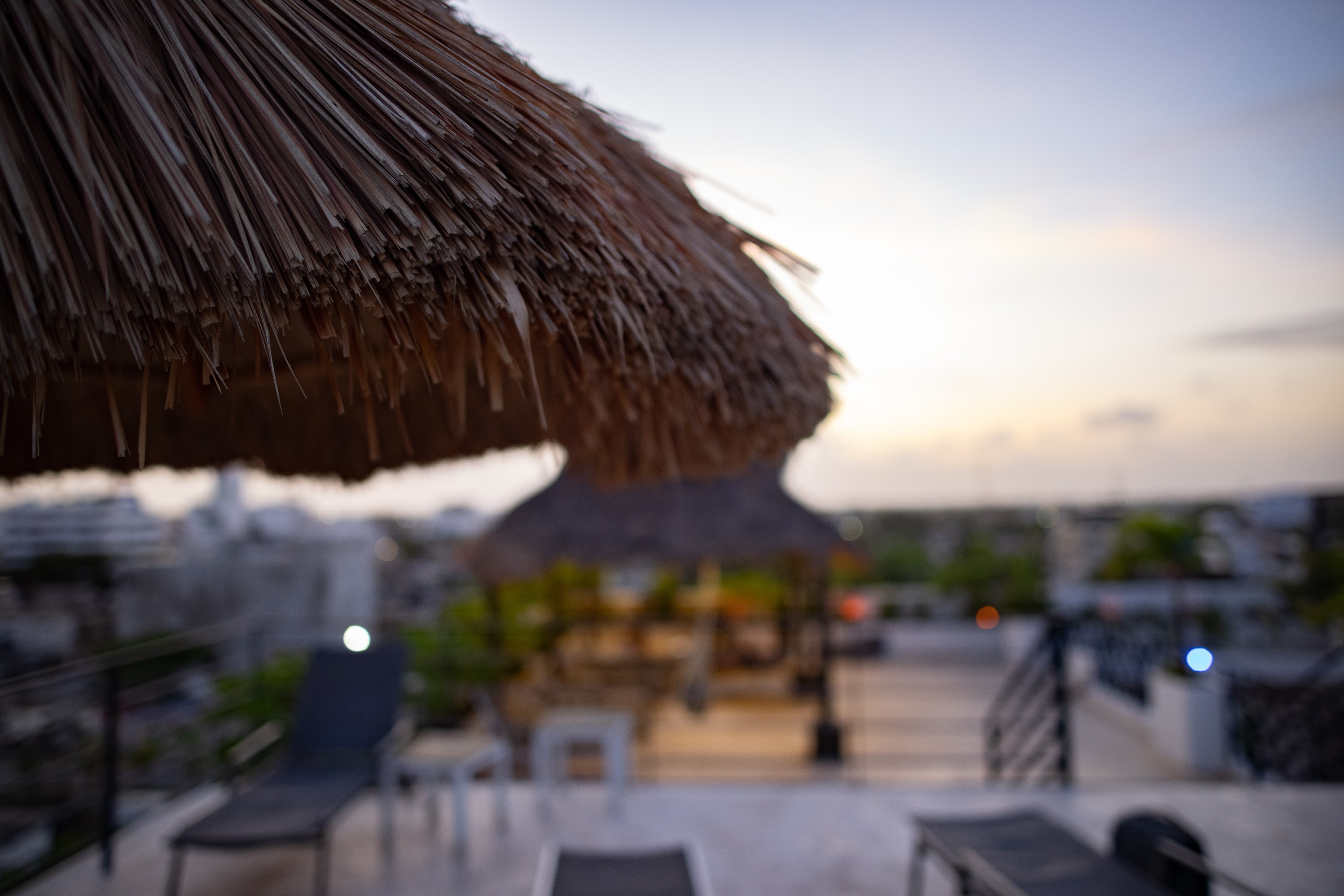 Rooftop Terrace at Dusk with Thatch Umbrella