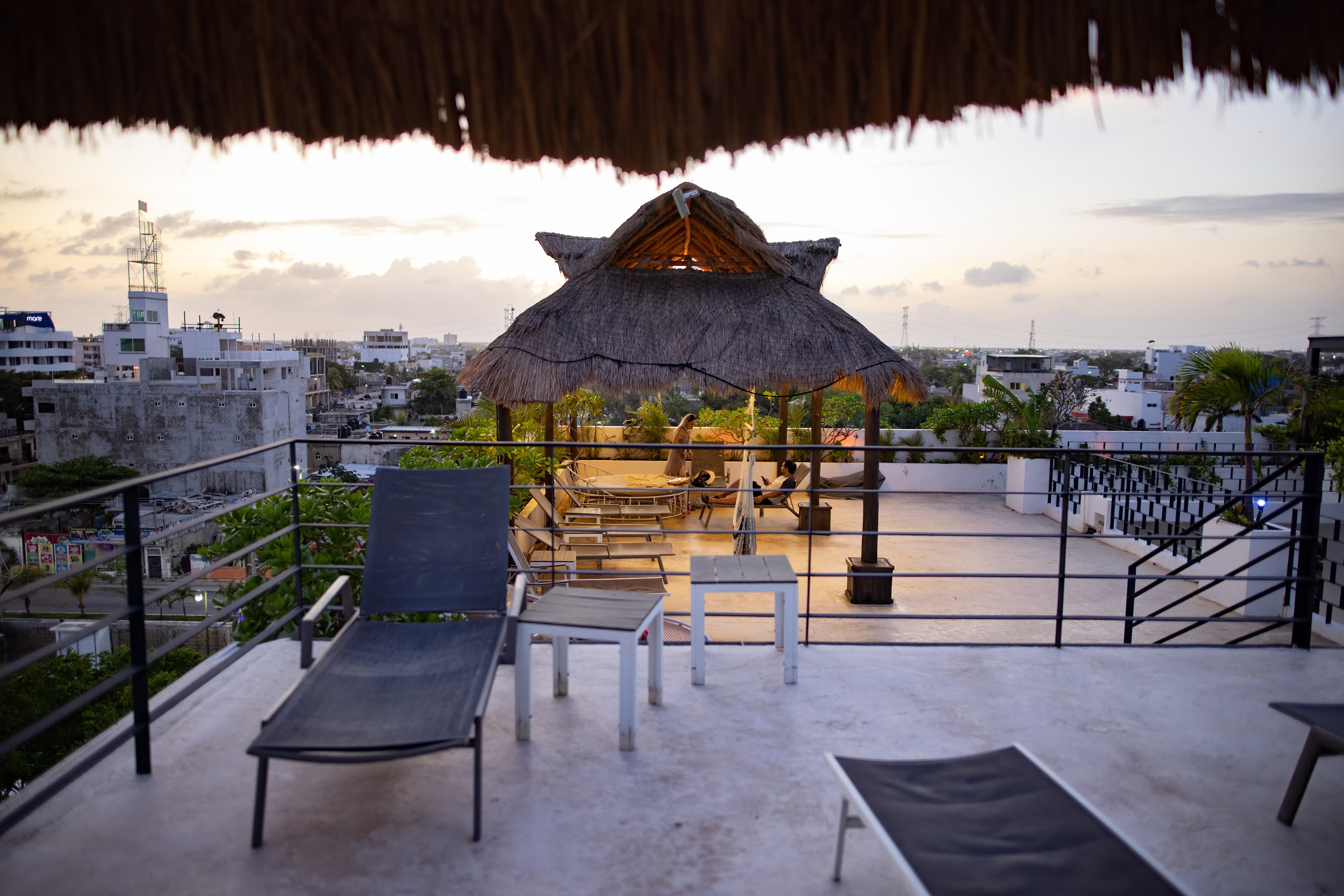 Rooftop Terrace with Thatched Umbrellas at Sunset