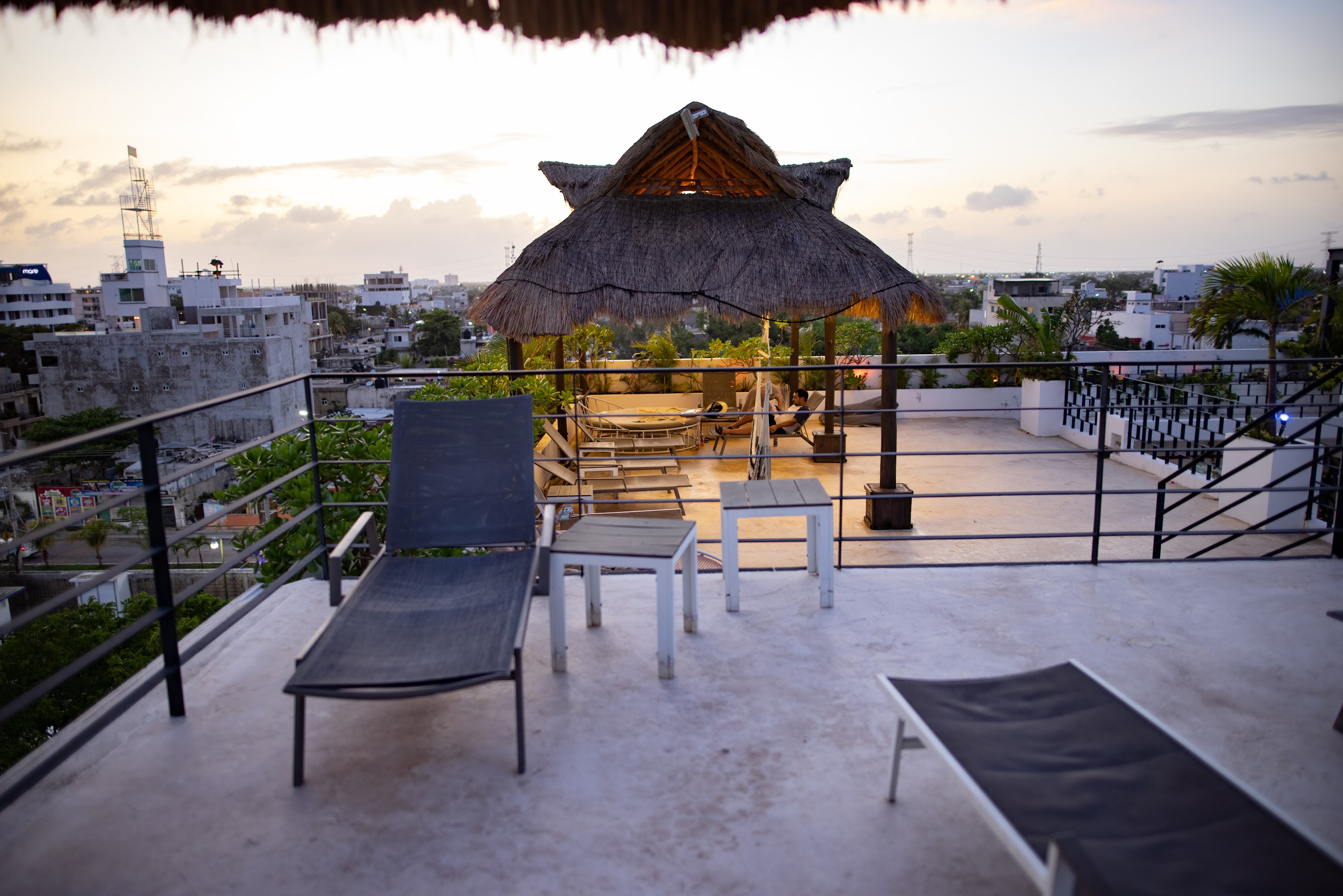 Rooftop Terrace with Thatched Gazebo at Sunset