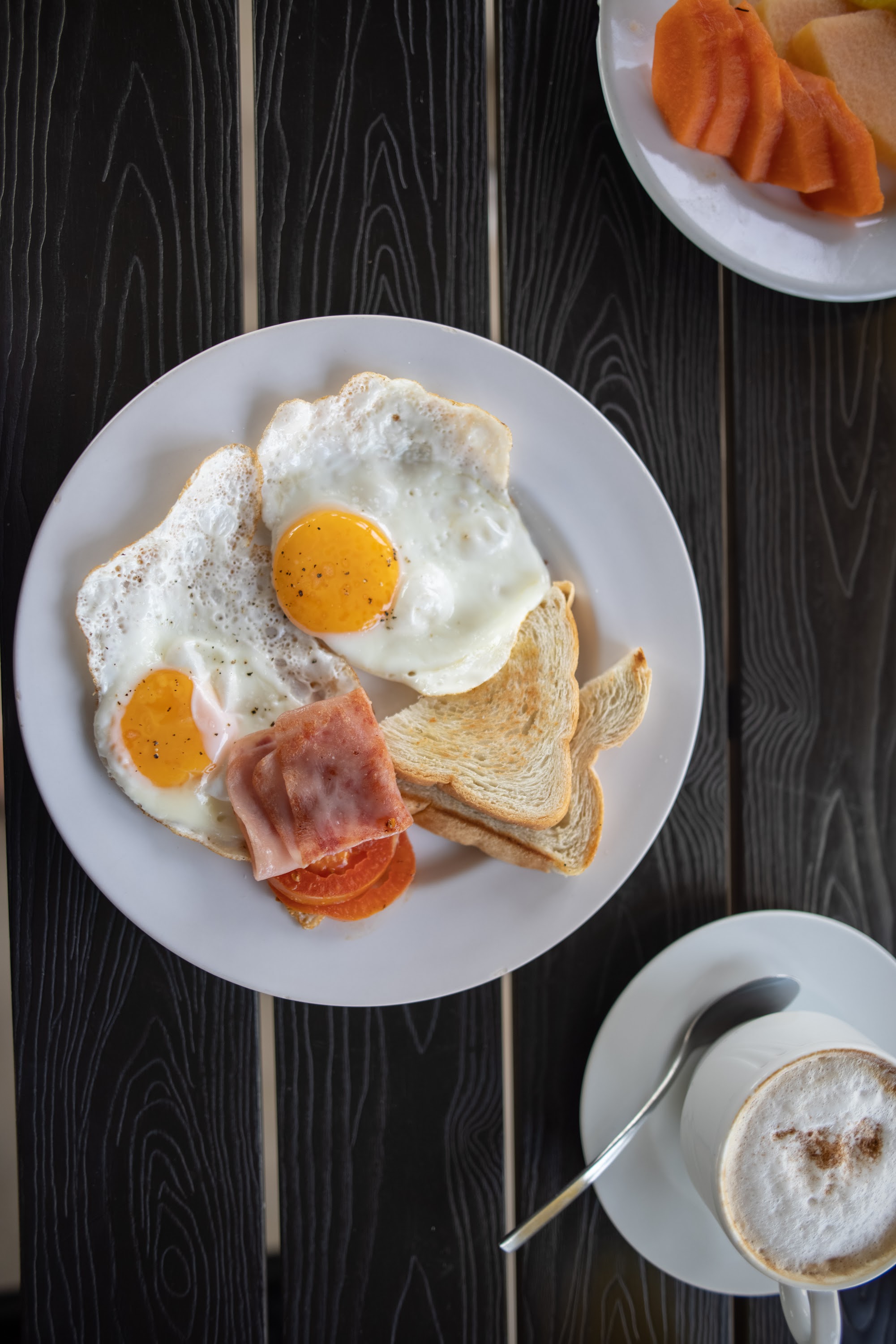 Breakfast Plate with Fried Eggs, Toast, and Coffee