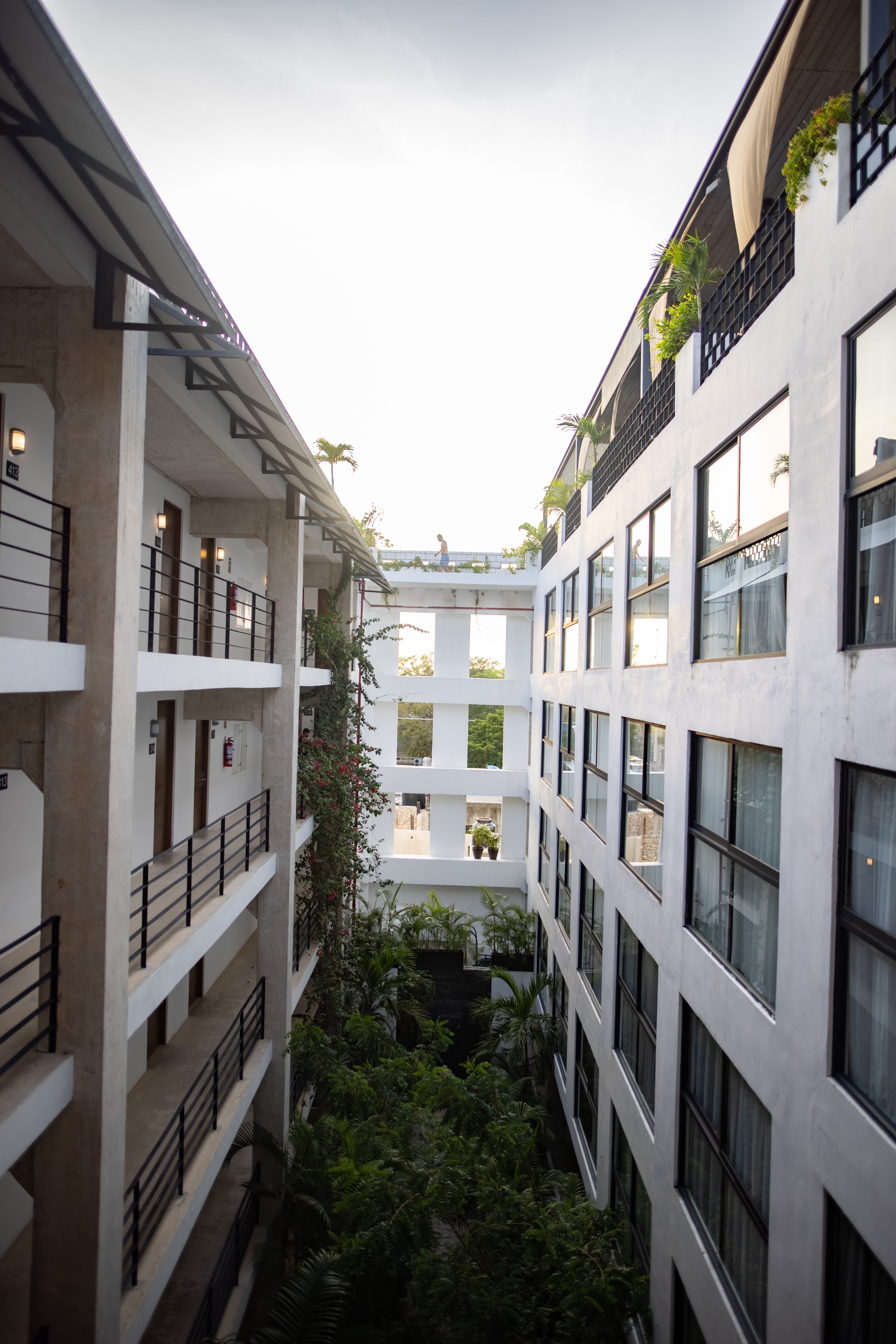 Modern Hotel Courtyard with Greenery and Balconies