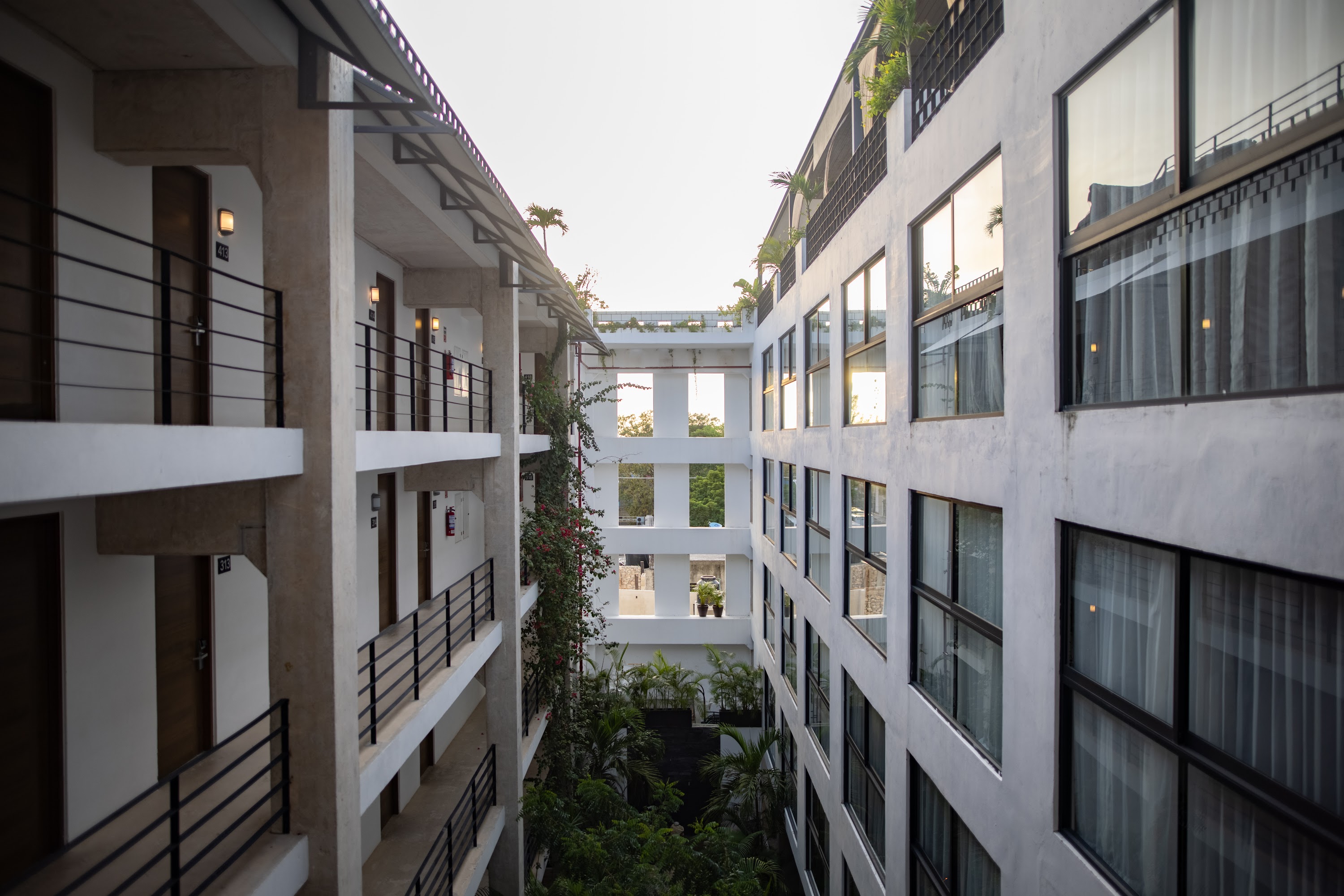 Modern Hotel Courtyard with Balconies and Greenery