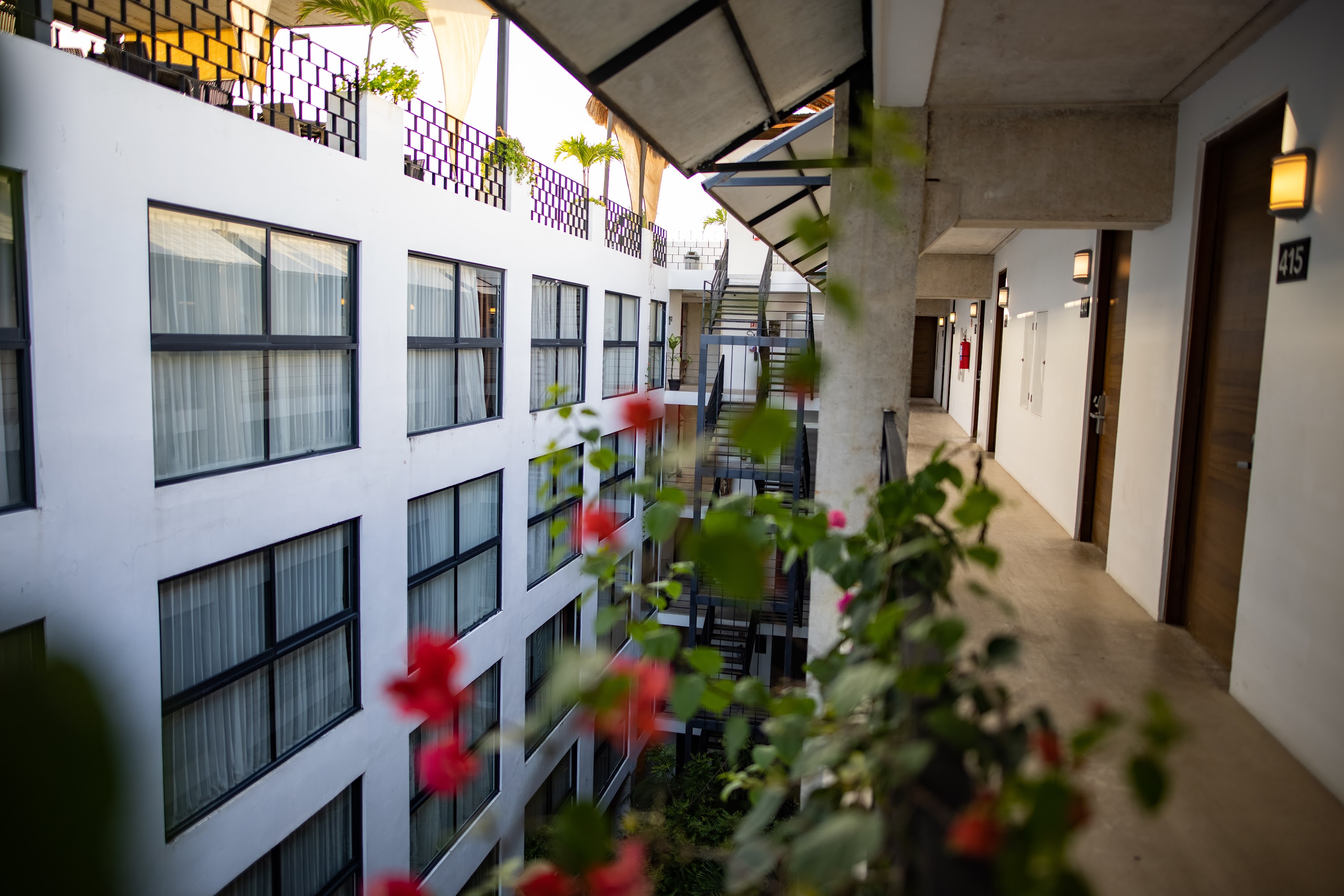 Modern Hotel Courtyard with Blooming Flowers and Balconies