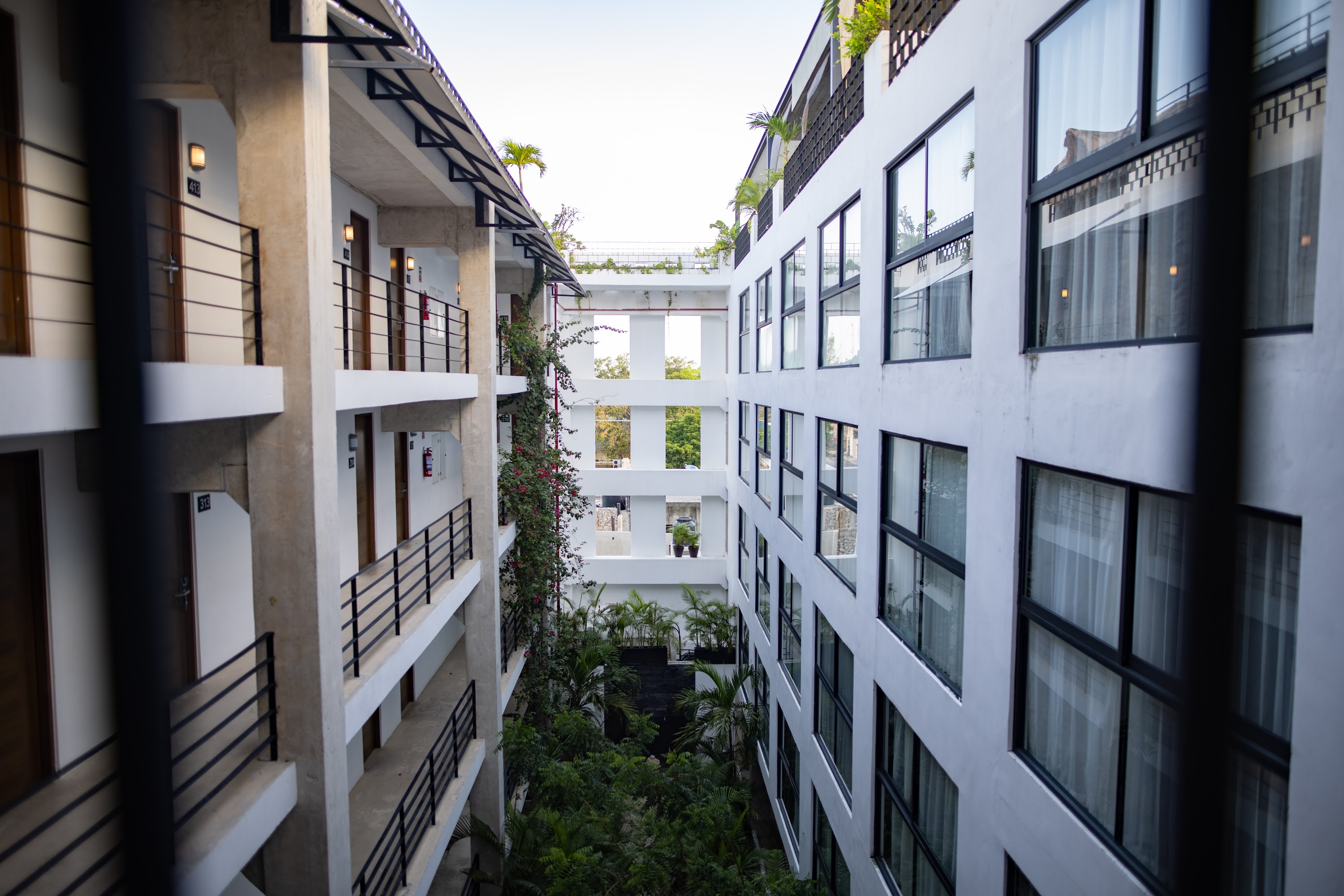 Modern Hotel Courtyard with Balconies and Greenery