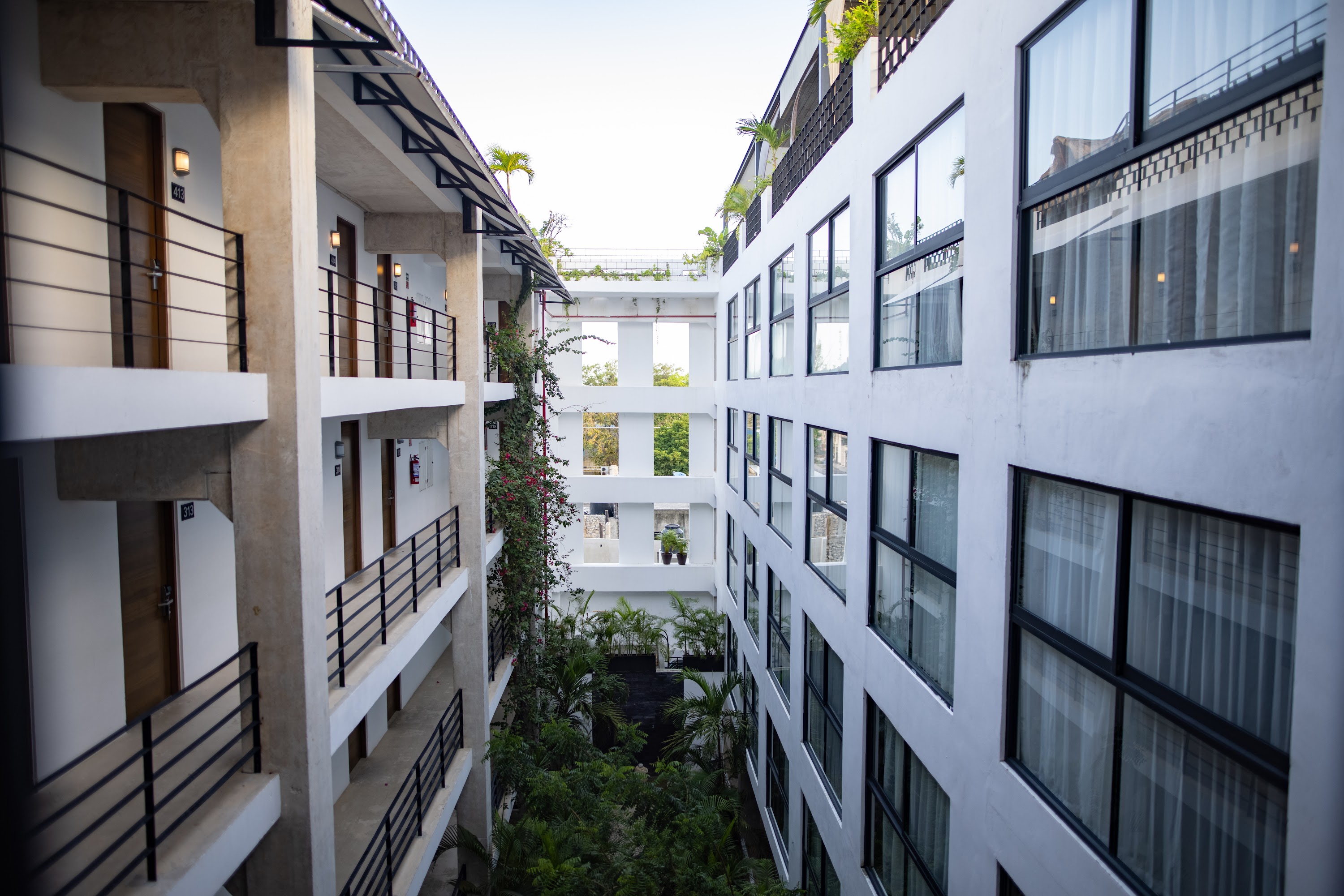 Modern Hotel Courtyard with Balconies and Greenery