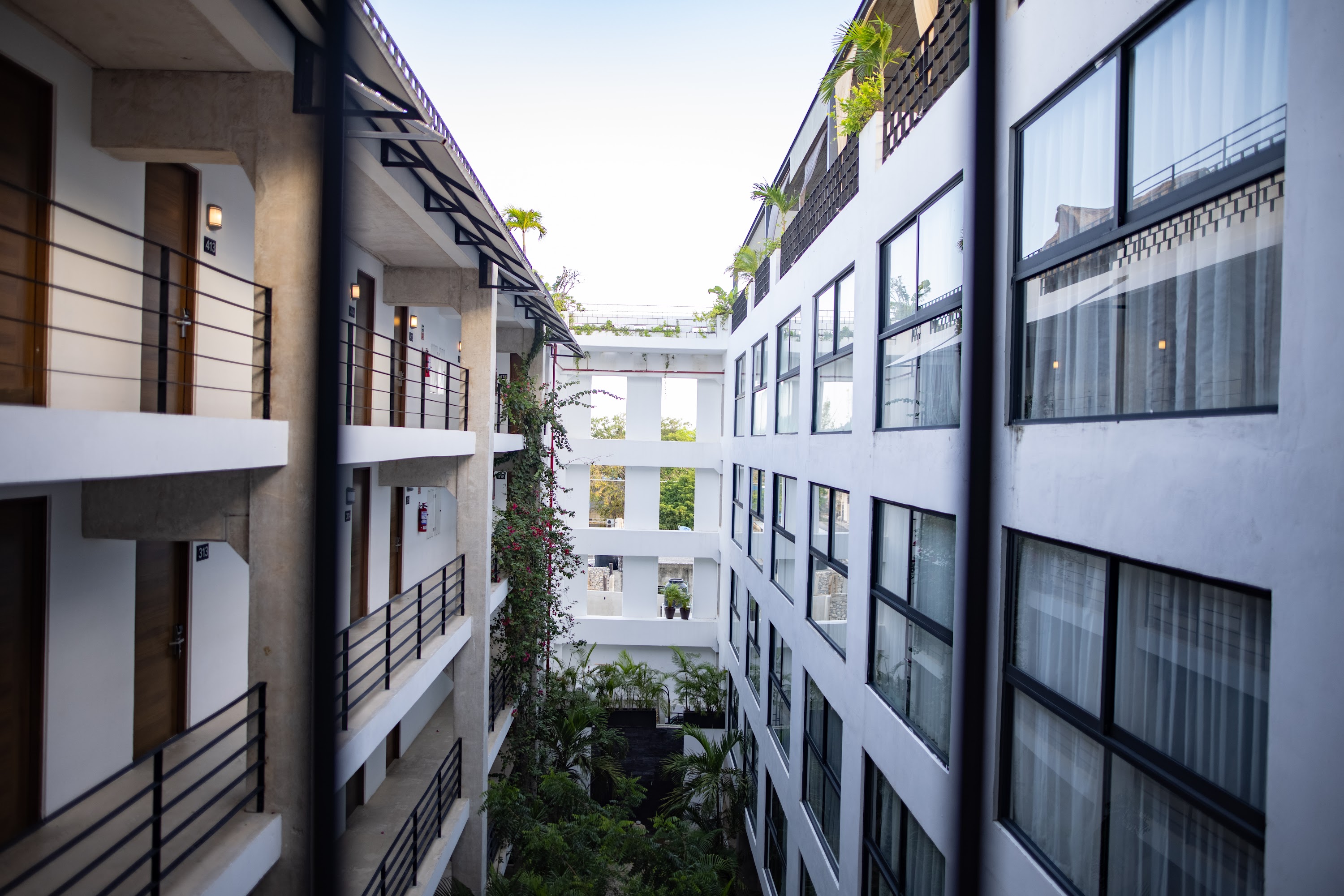 Modern Hotel Courtyard with Balconies and Greenery
