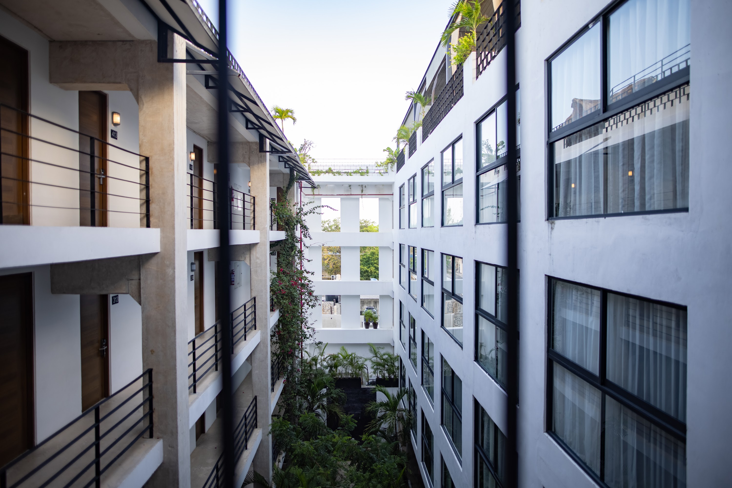 Modern Hotel Courtyard with Balconies and Greenery