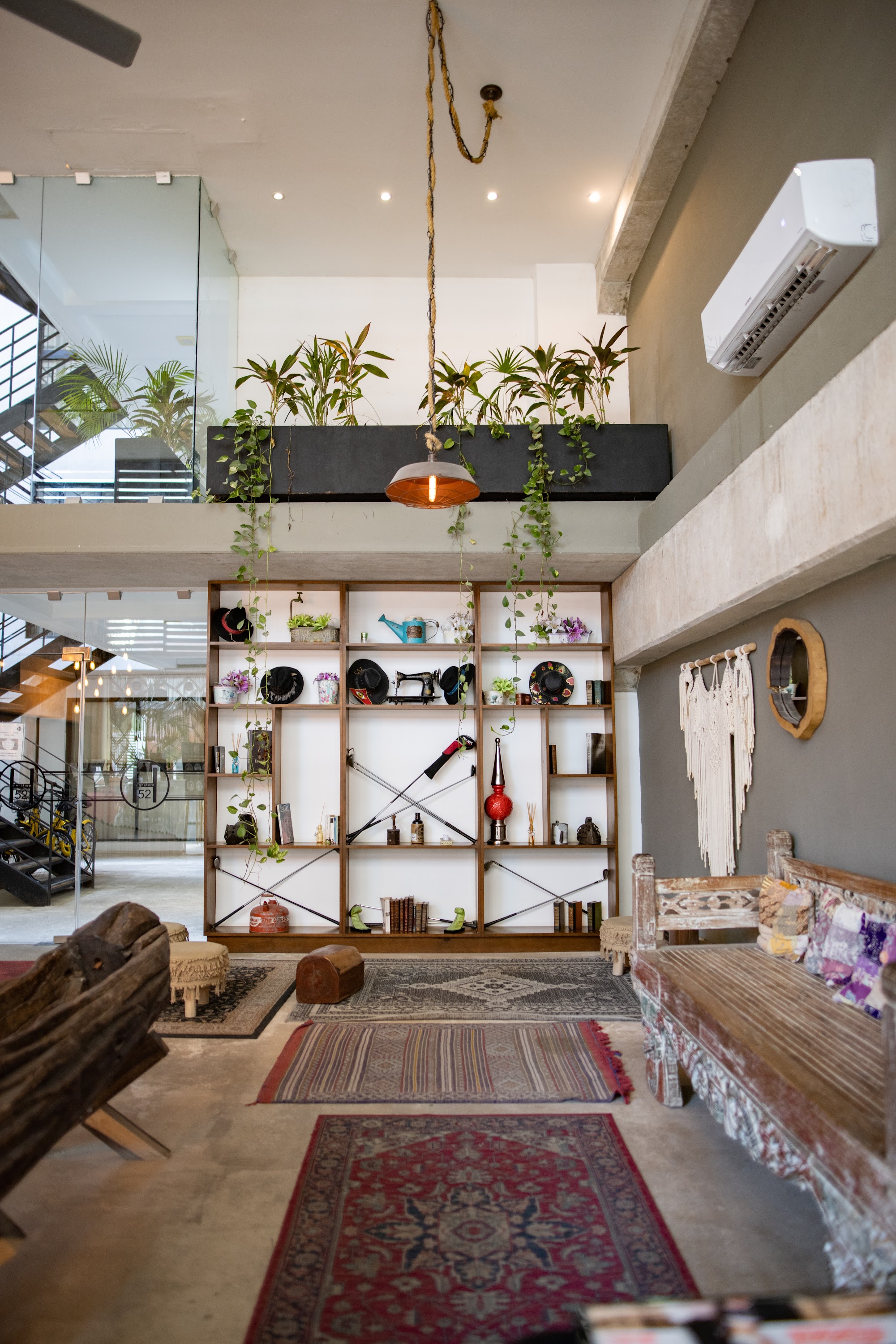Bohemian-style interior with wooden shelving, hanging plants, and vintage decor