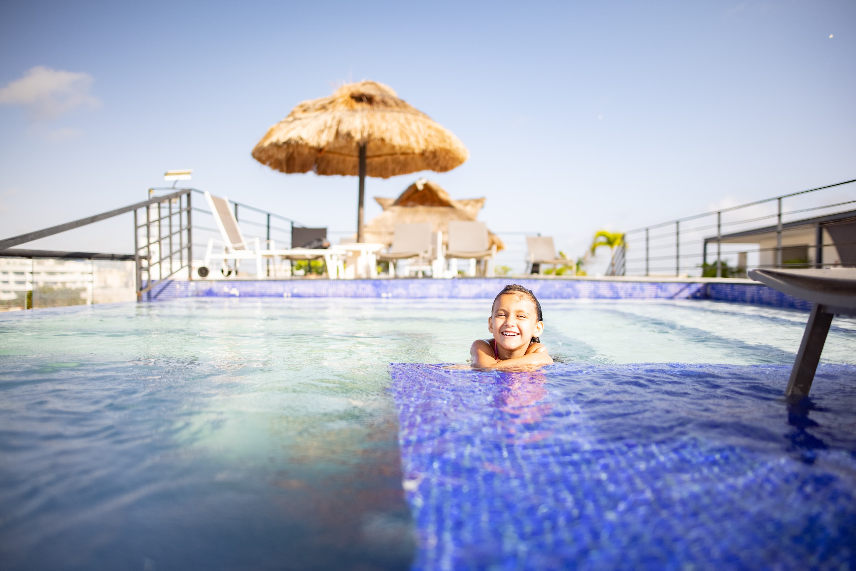 Happy Child Swimming in Rooftop Pool