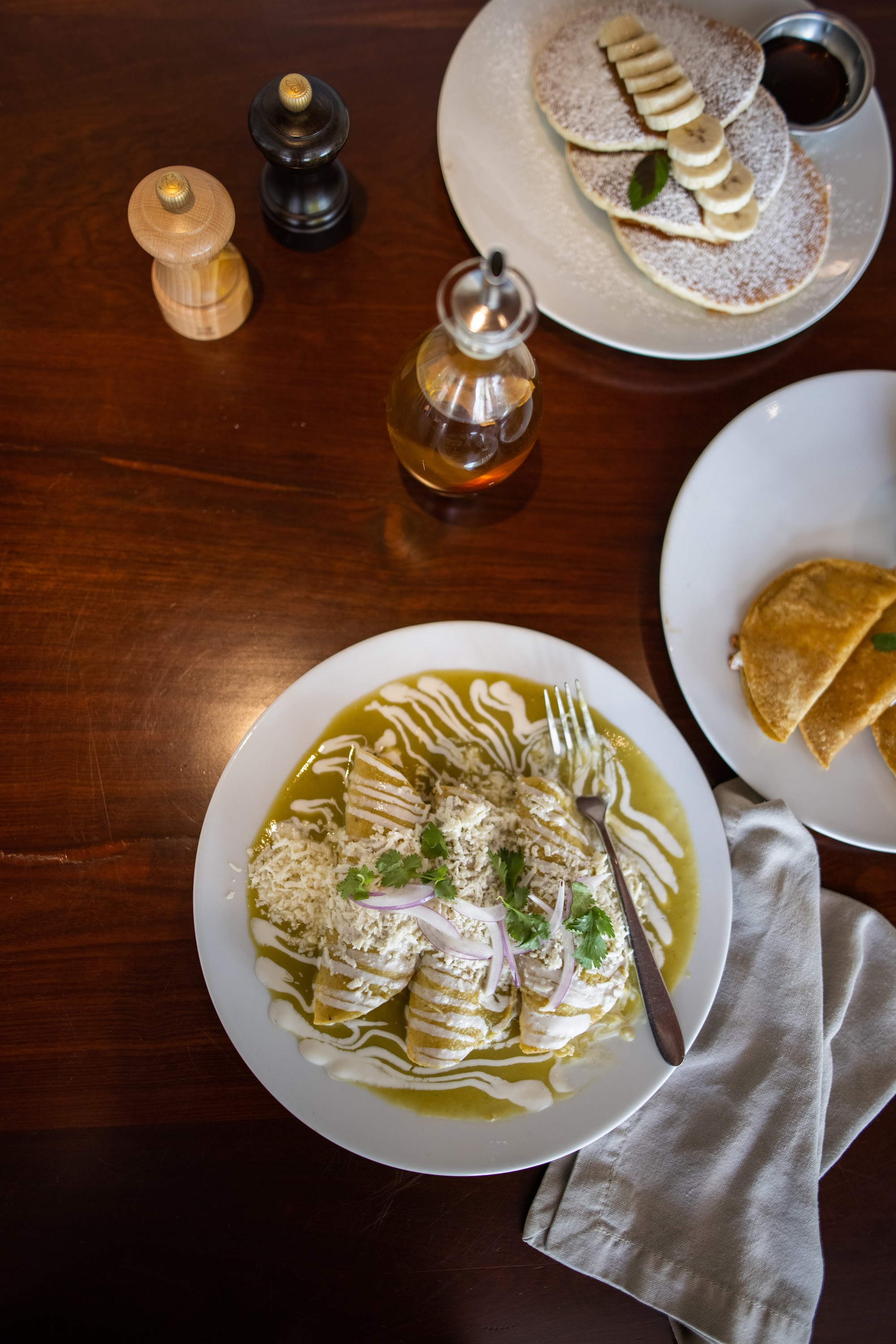Breakfast and Mole Enchiladas on a Wooden Table