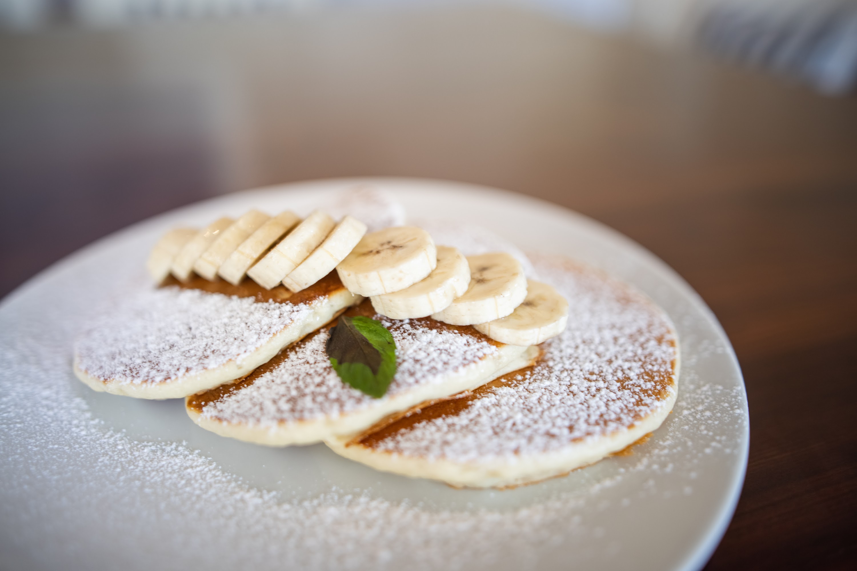 Stack of Banana Pancakes with Powdered Sugar