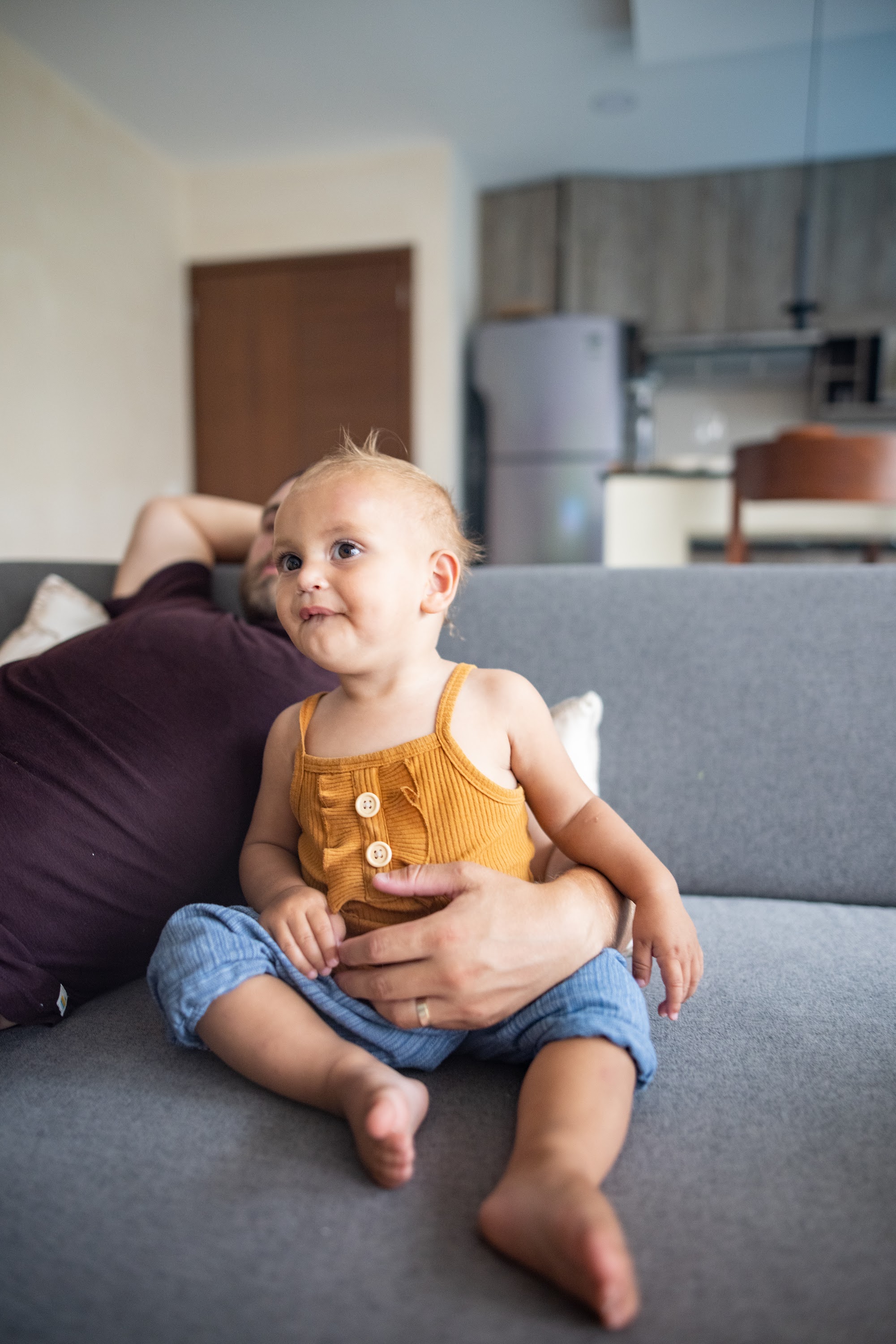Baby Sitting on Couch with Parent
