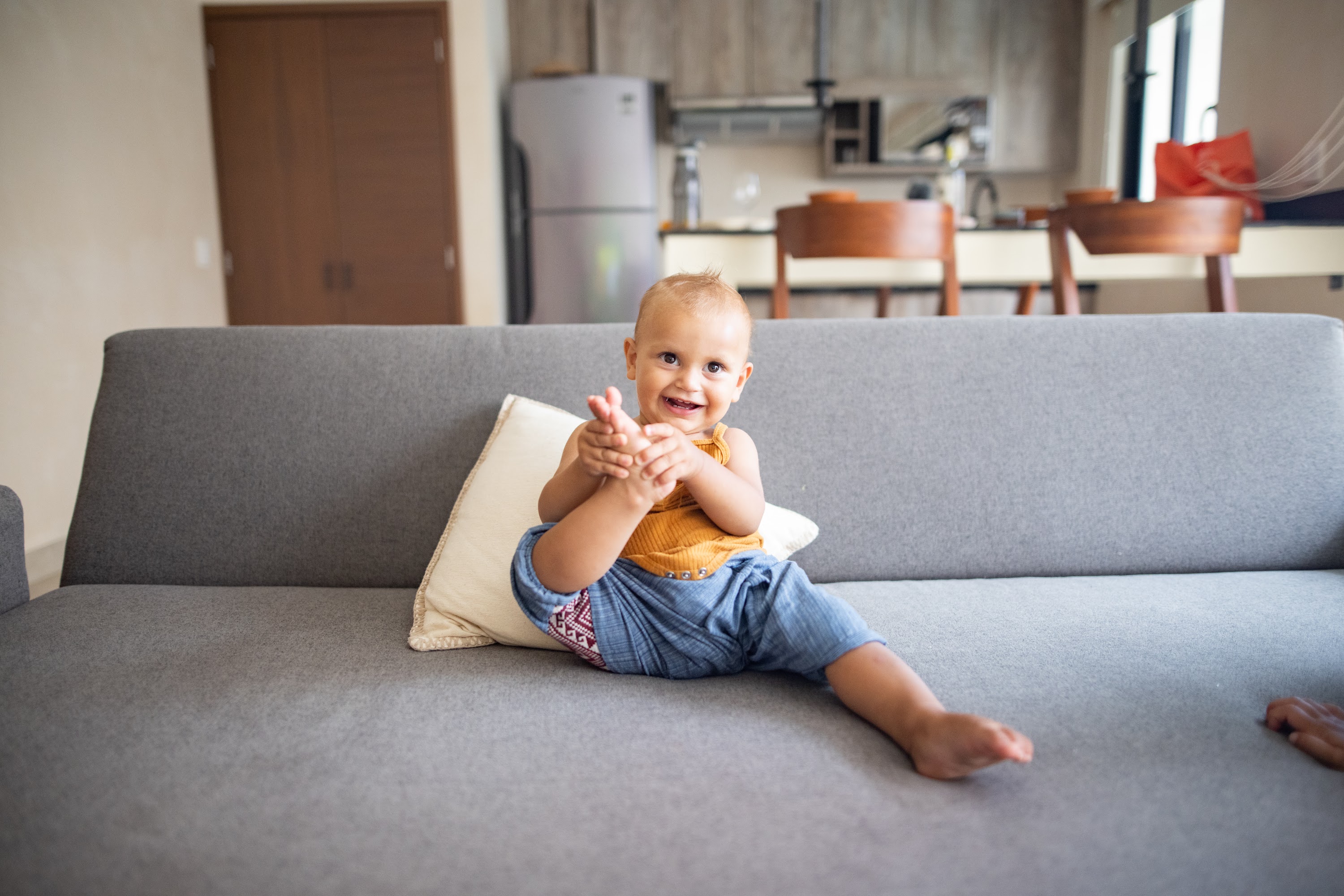 Happy Baby Clapping on Gray Couch
