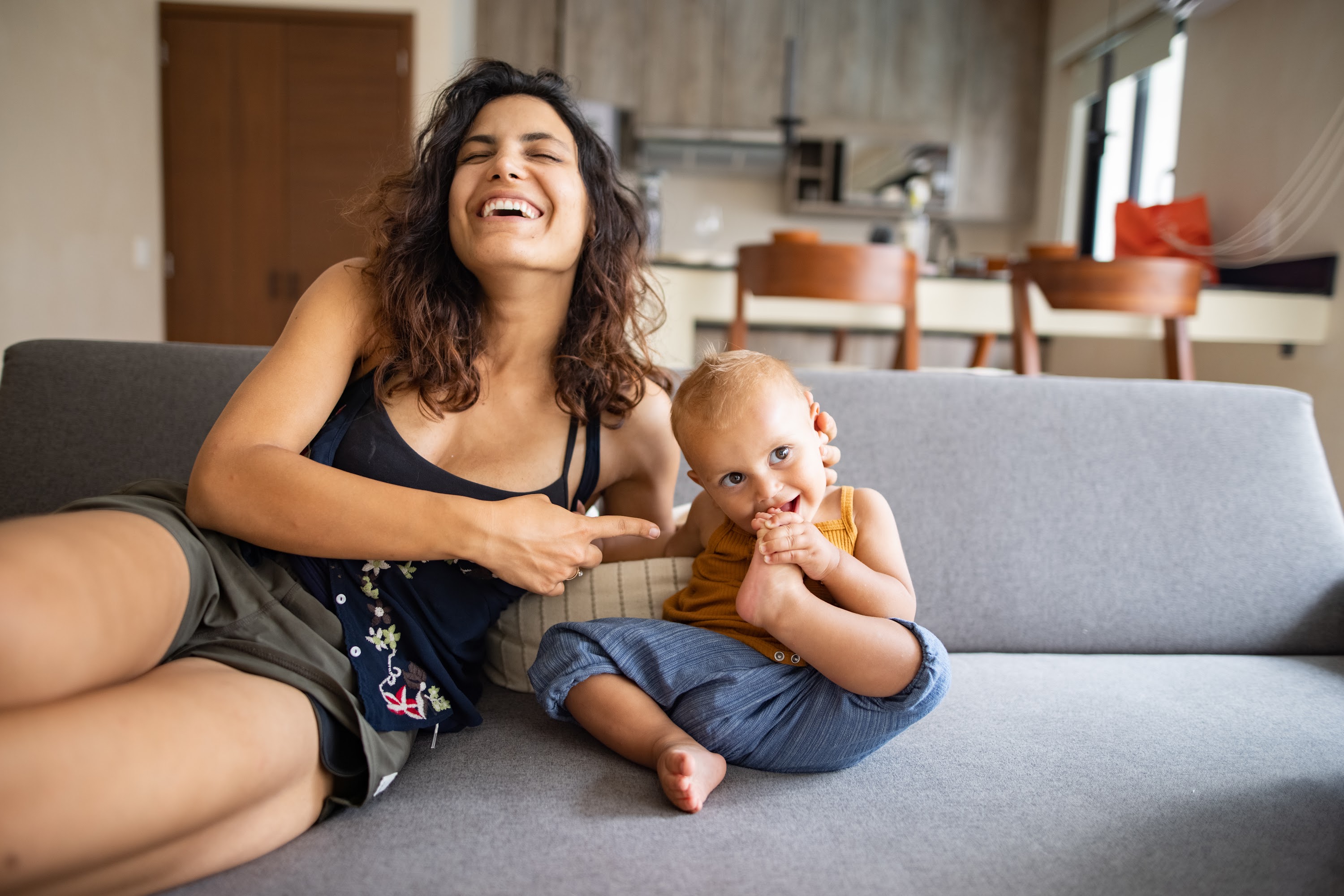 Mother and Baby Laughing on Couch