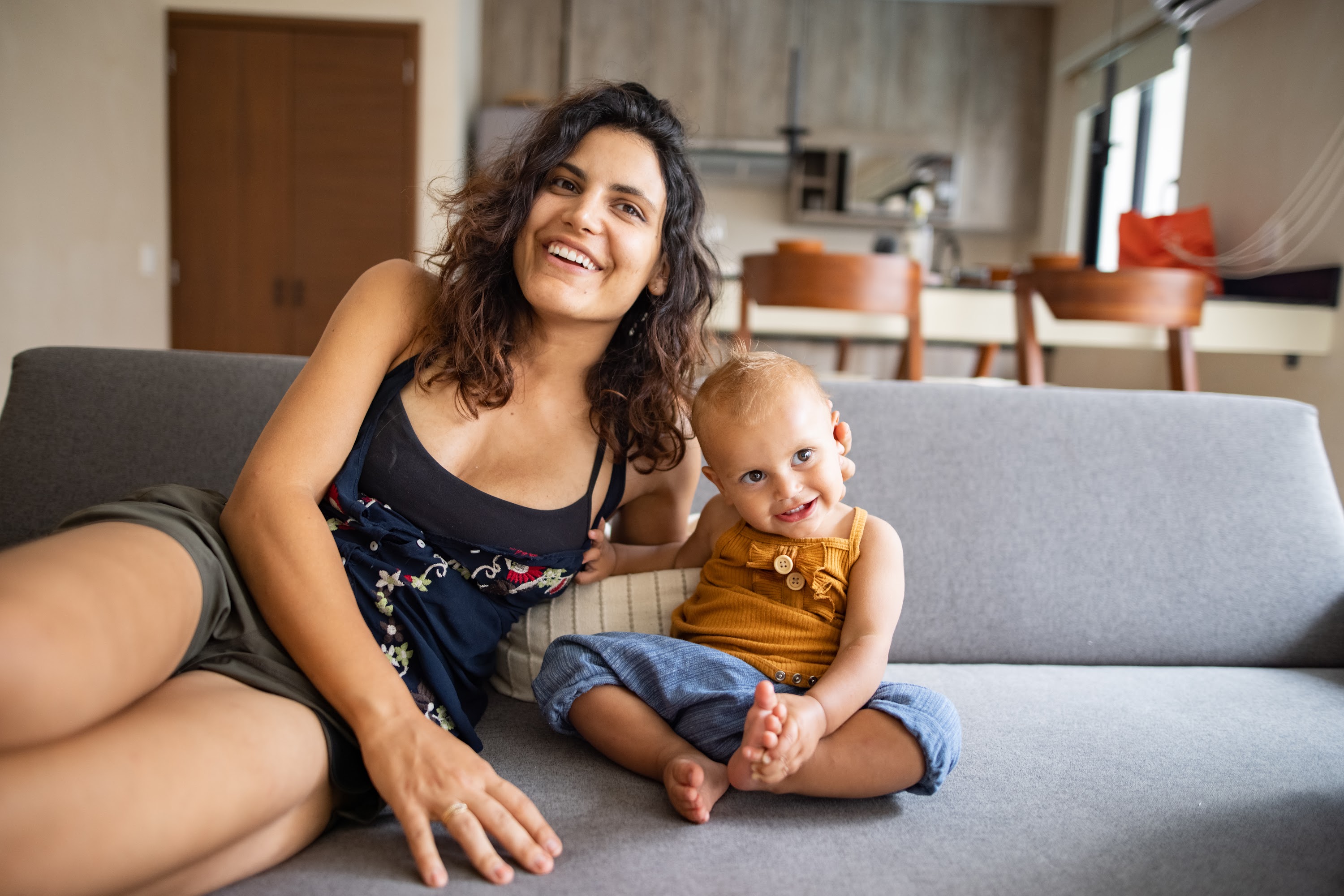 Smiling Mother and Baby on Couch
