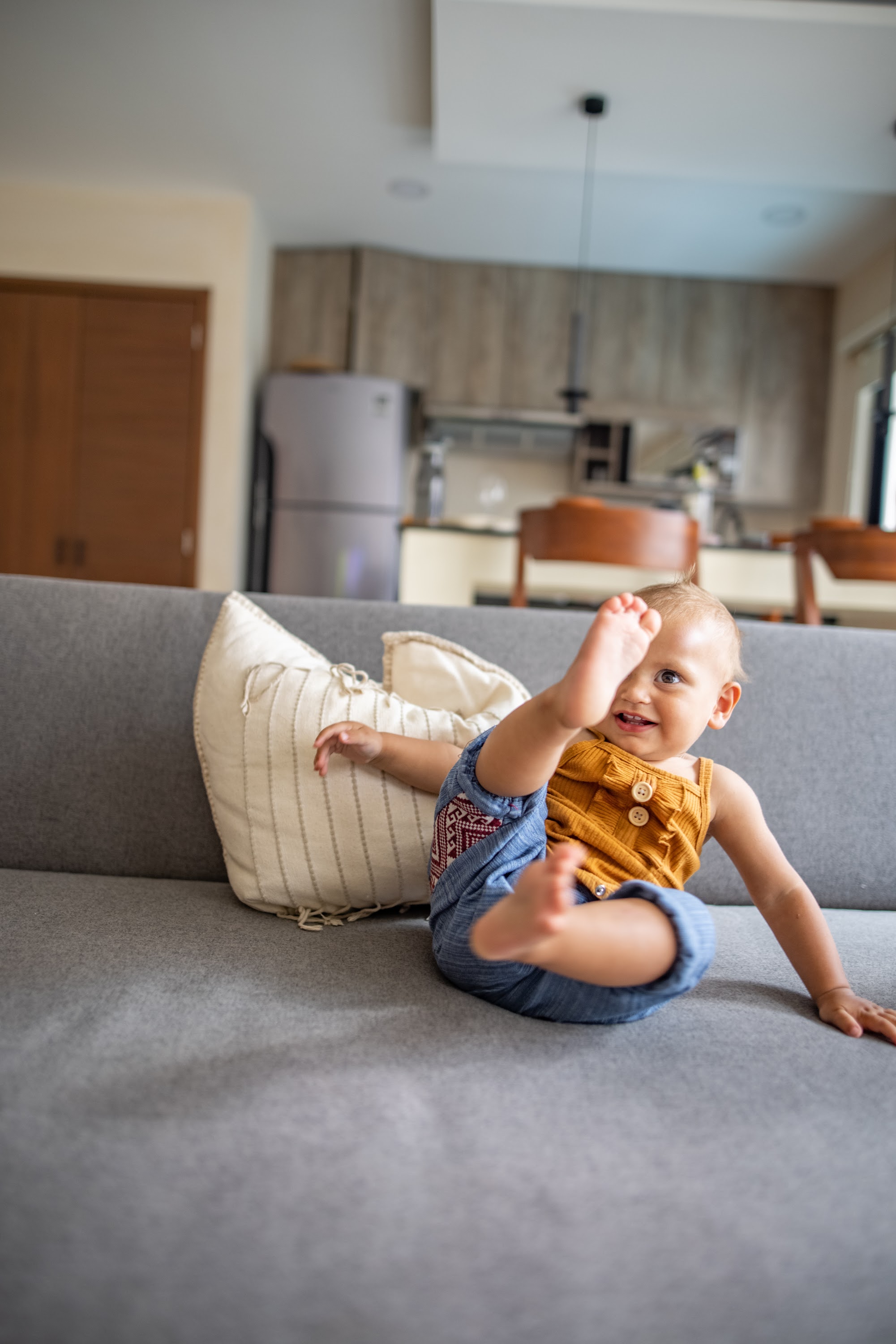 Happy Baby on Gray Sofa
